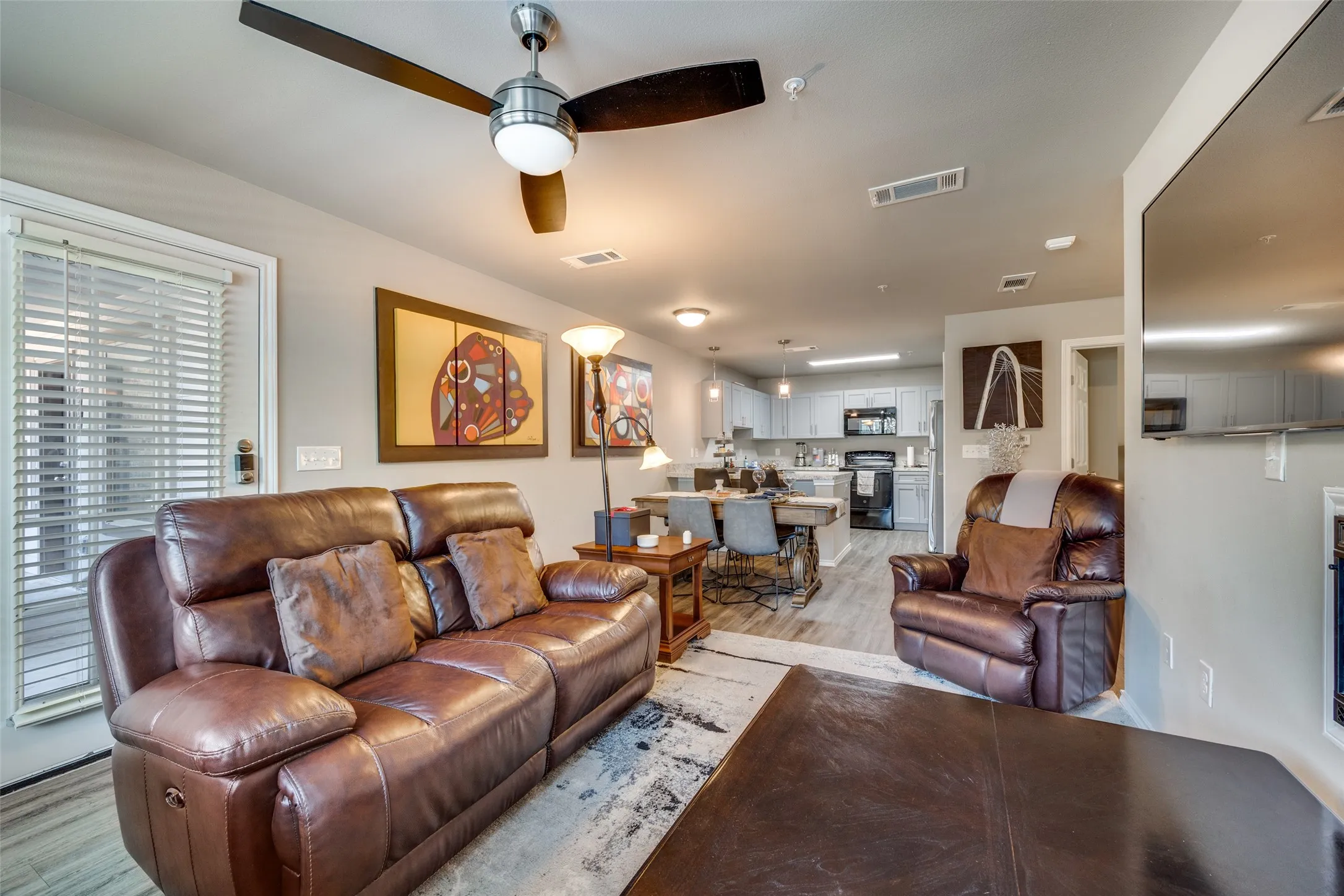 Living room featuring light wood finished floors and ceiling fan
