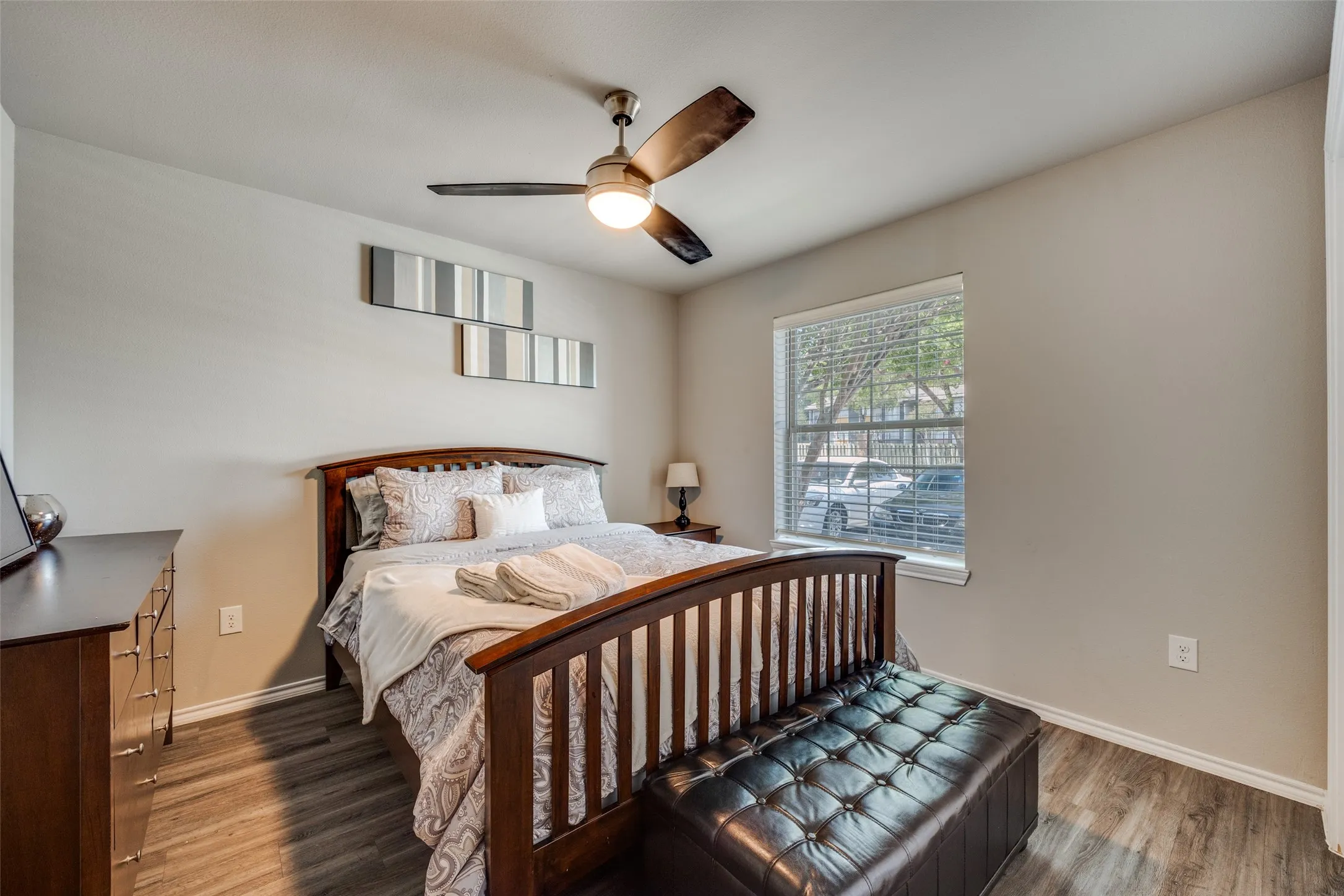 Bedroom with wood finished floors and ceiling fan
