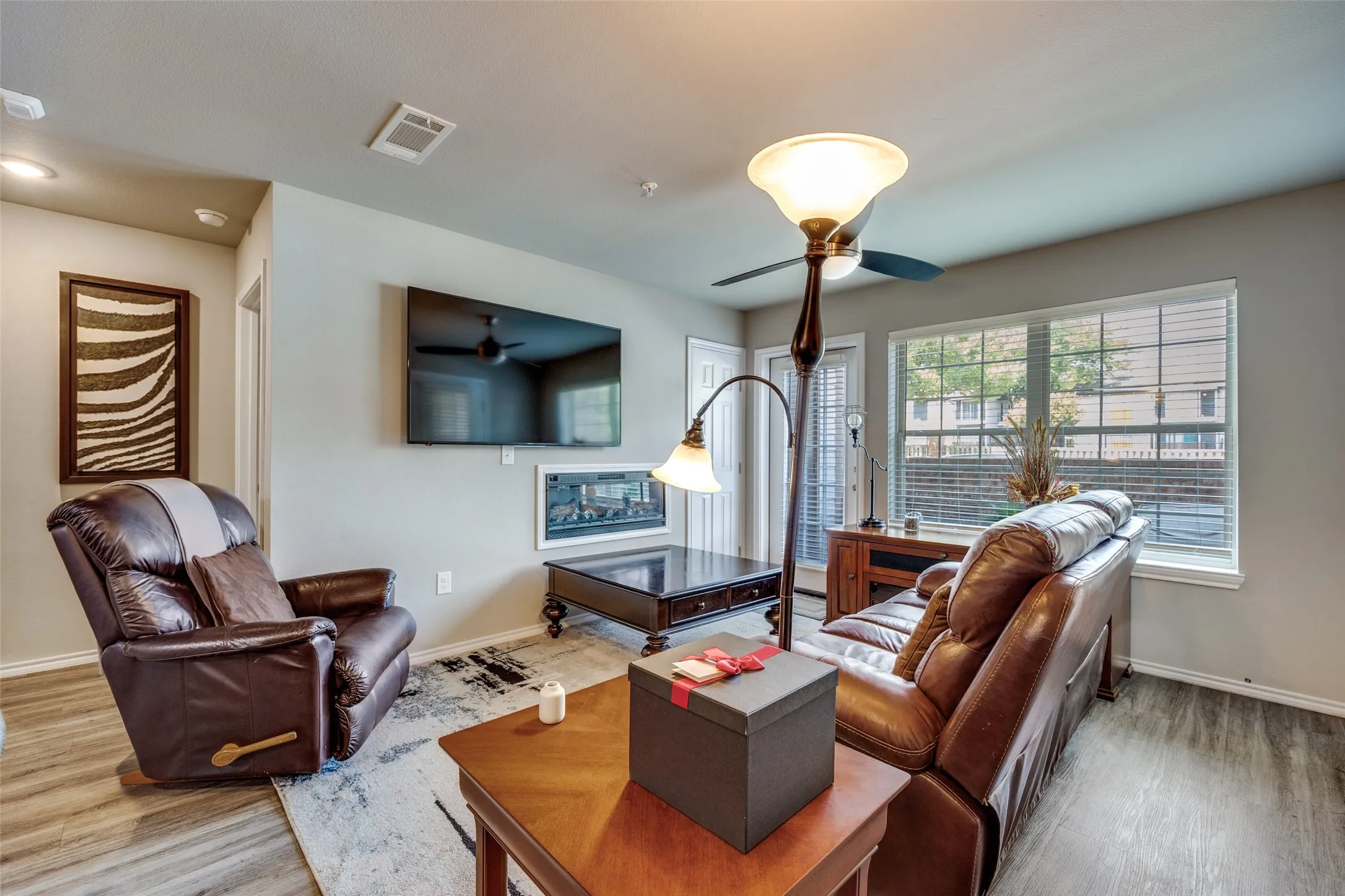 Living area featuring wood finished floors and ceiling fan