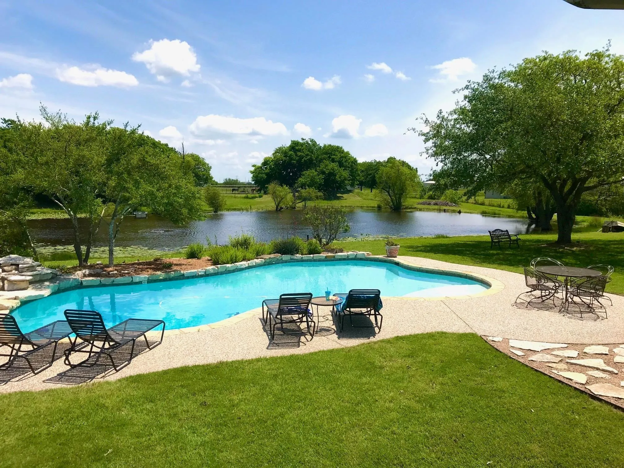 Property has mature trees & a picturesque 1.5-acre, stocked fishing pond