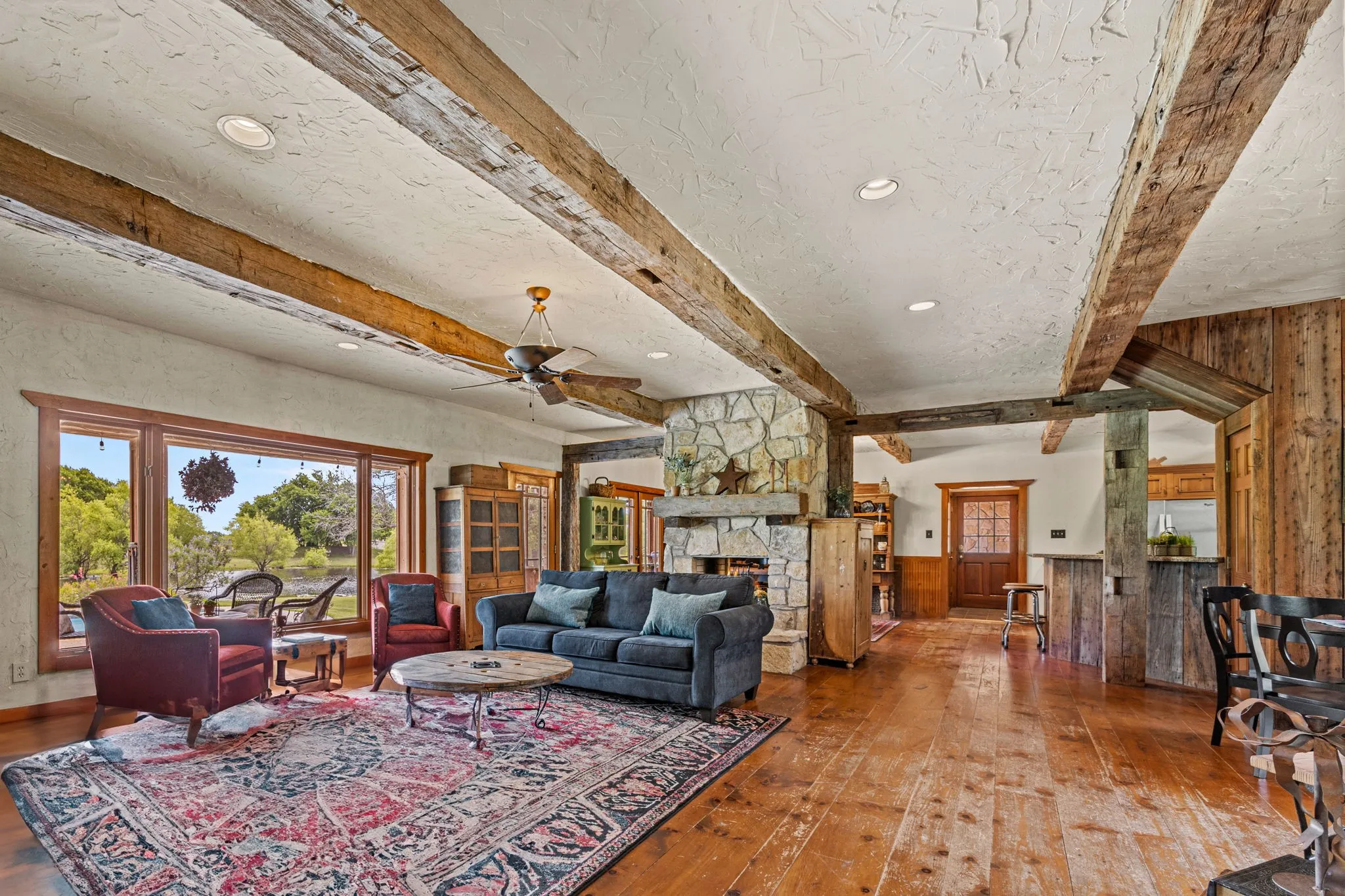 Recently re-stained soft pine floors, massive solid oak beamed ceilings & a see-thru fireplace that adds warmth & character to the newly-painted kitchen