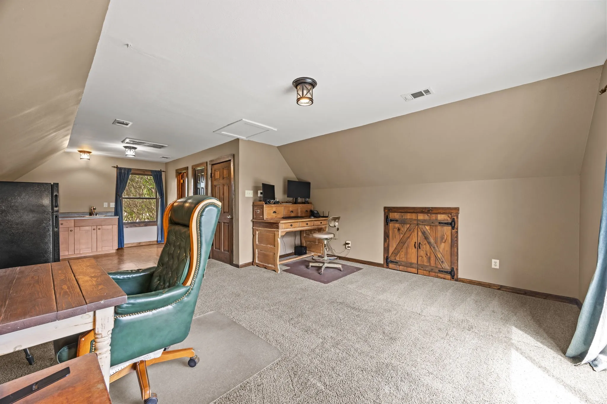 Apartment above garage features full bath, kitchenette w/sink & refrigerator & stove hookups, as well as a tankless water heater
