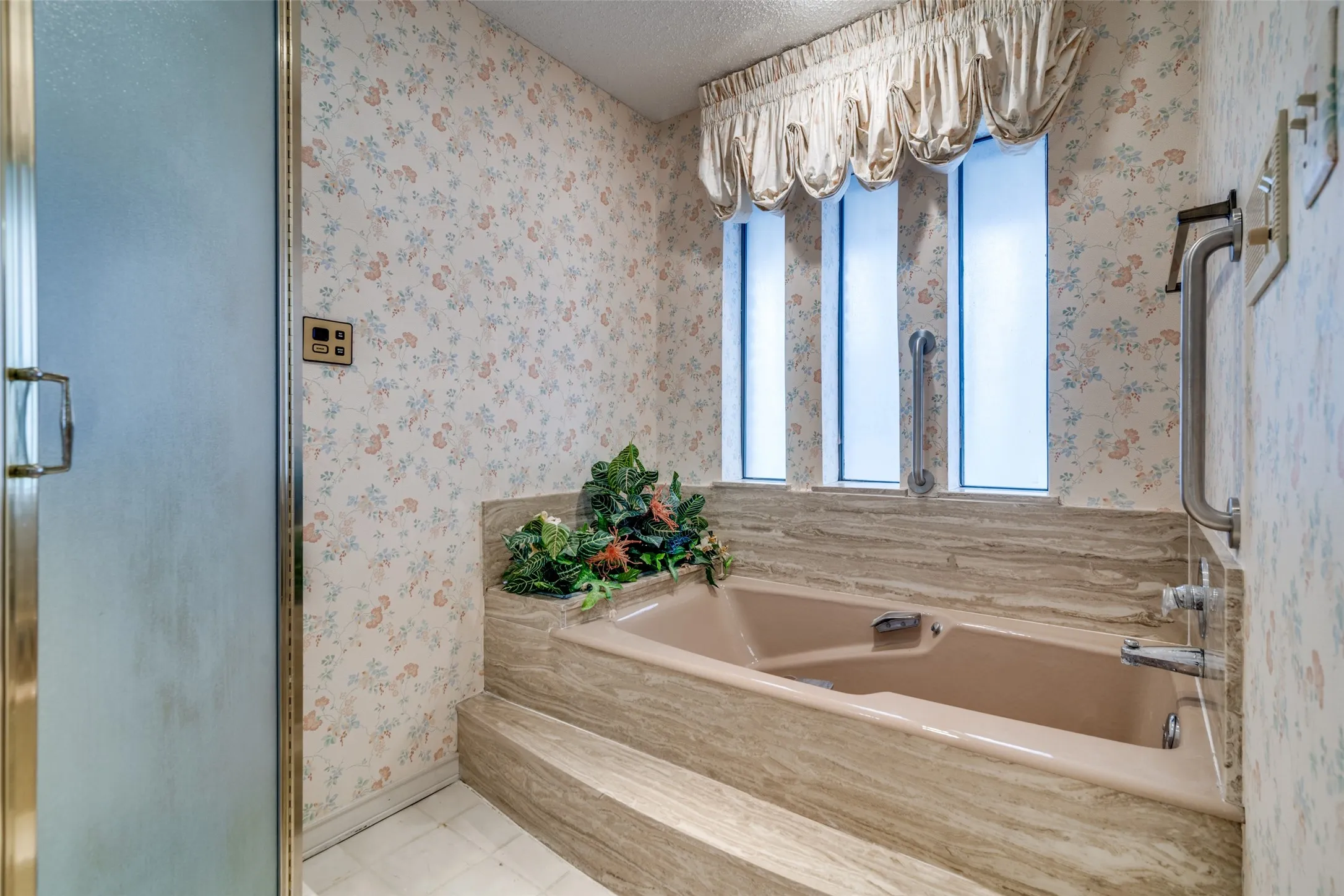 A jetted tub and separate shower are in the primary bedroom