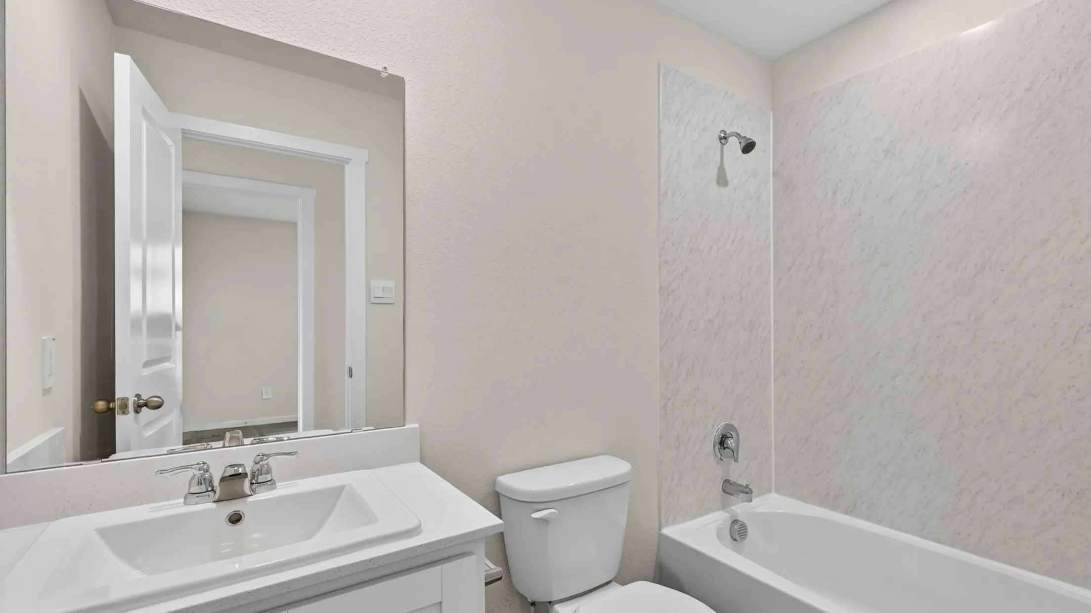 Bathroom featuring a vanity with a white countertop, an integrated sink, and a chrome faucet