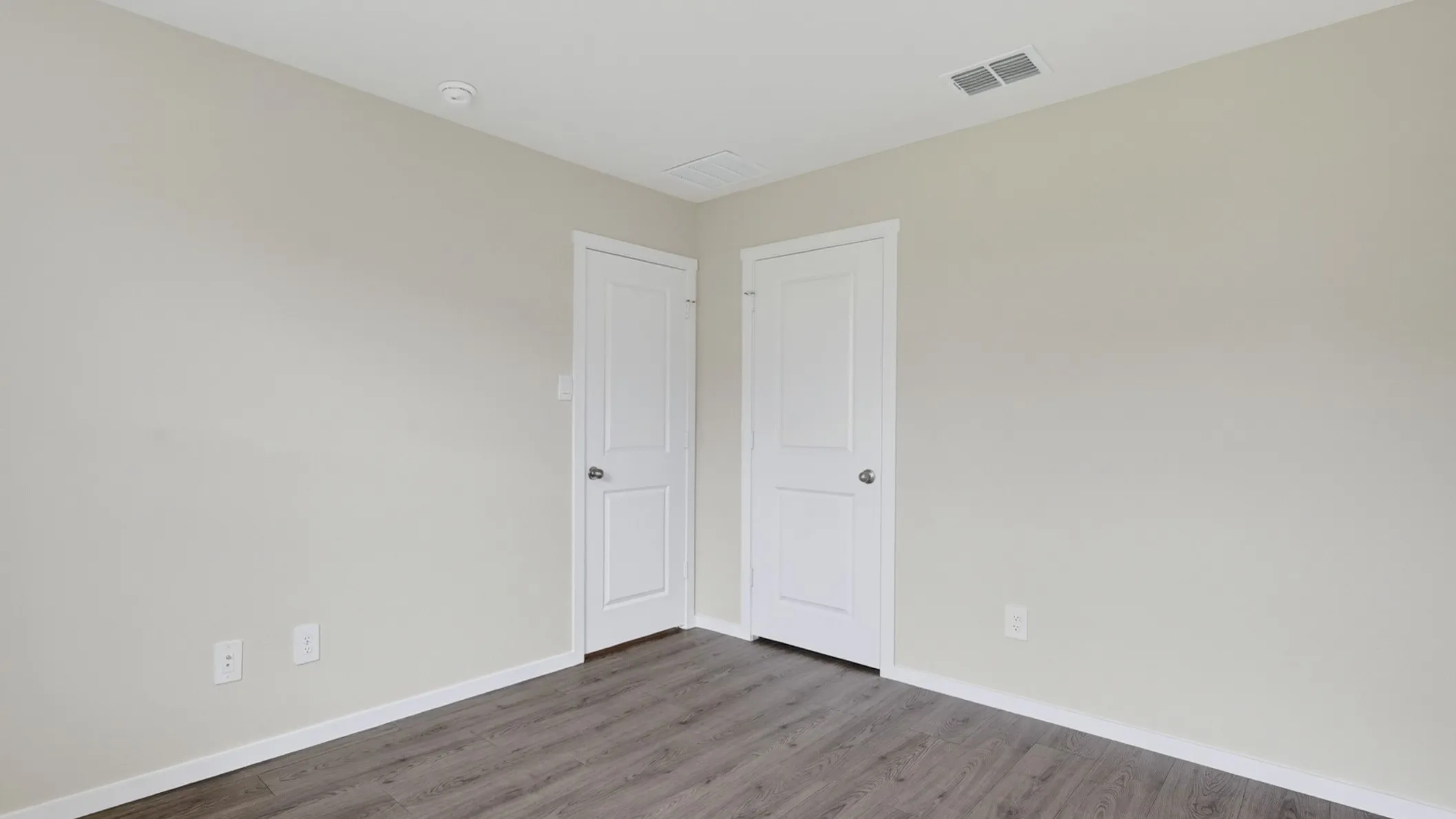 Neutral-toned walls complement wood-finish flooring