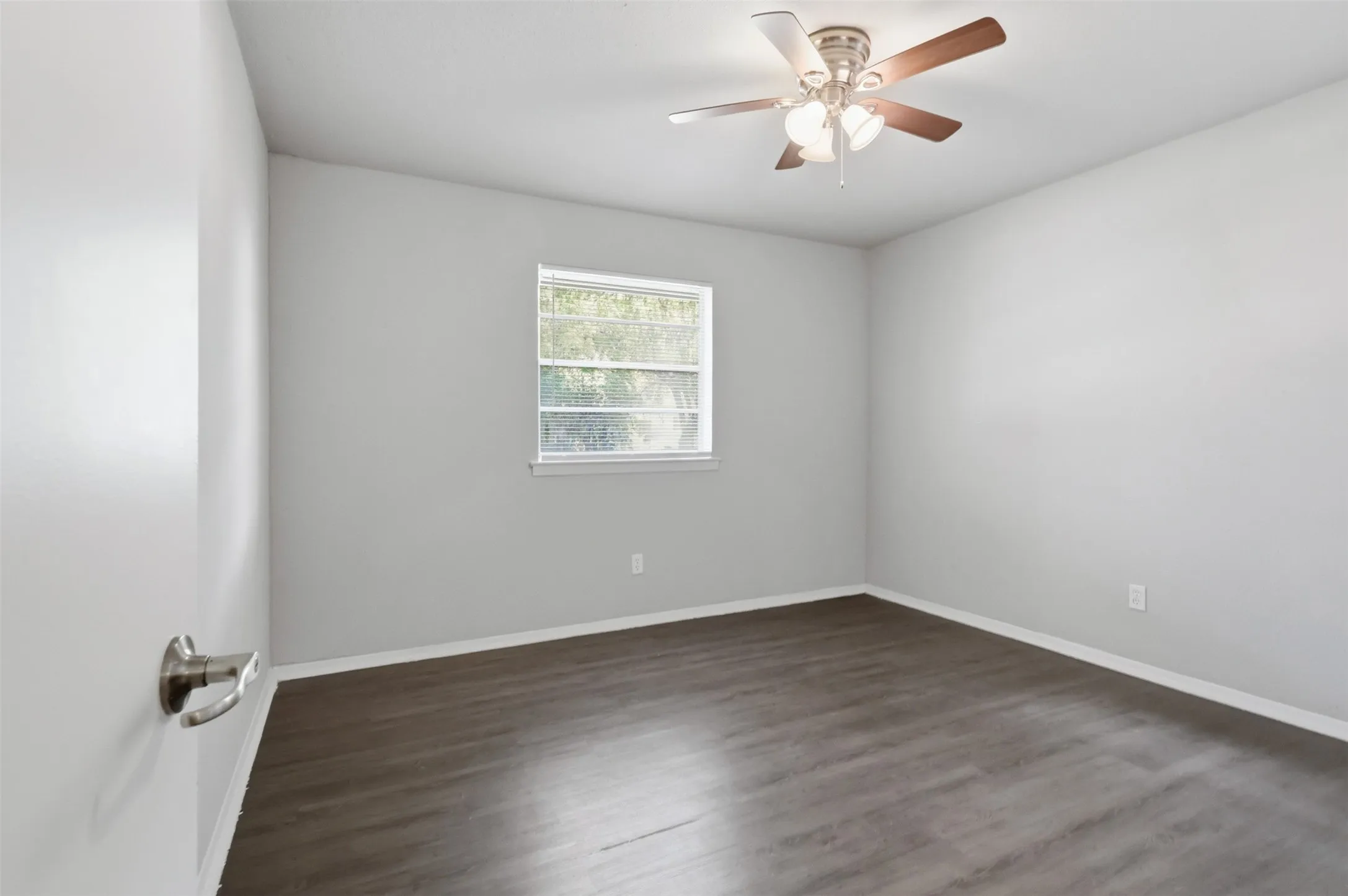 Secondary Bedroom with laminate flooring and ceiling fan.