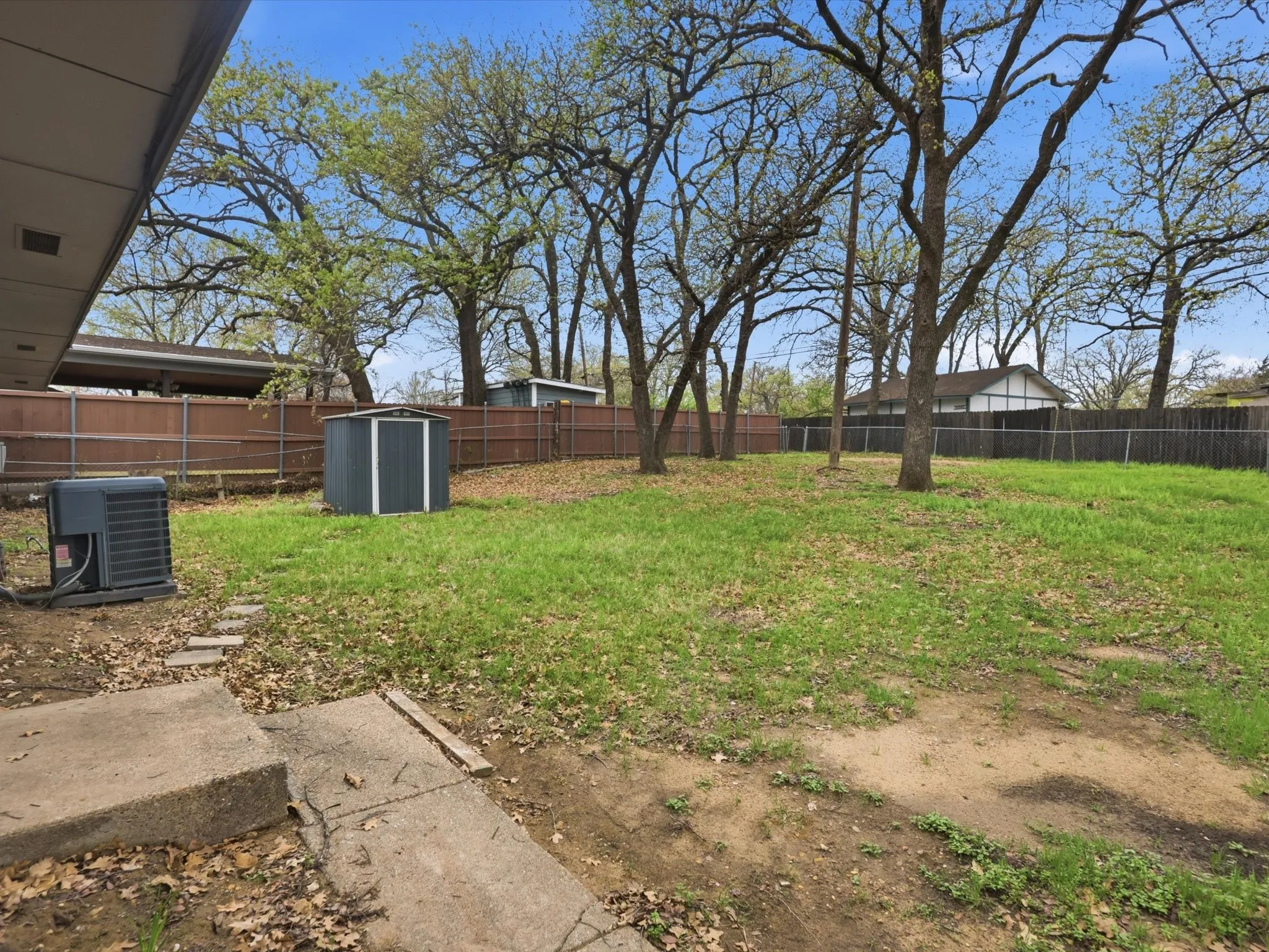 View of backyard from patio showcasing the large yard ready for family gatherings and outdoor fun.
