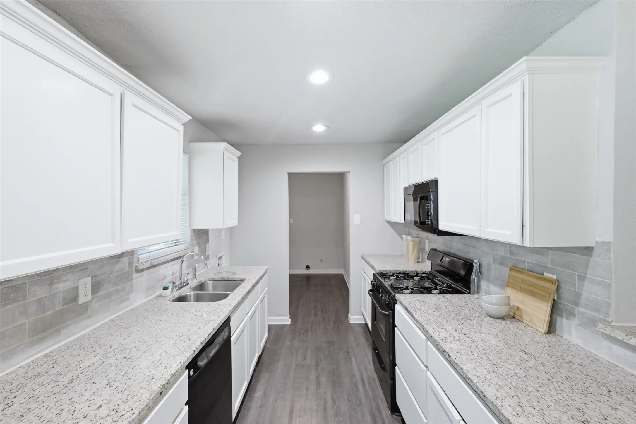 Kitchen opens to laundry room with access to the backyard and converted garage.