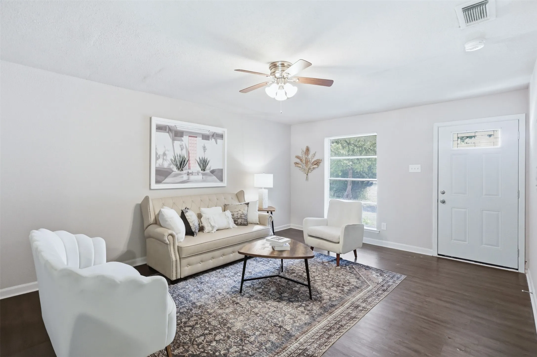 Living room features large front facing window for lots of natural light.