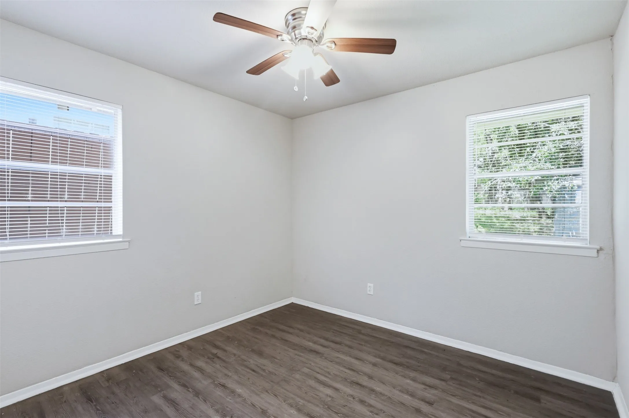 Third bedroom with Neutral wall tones, ceiling fan and laminate flooring.