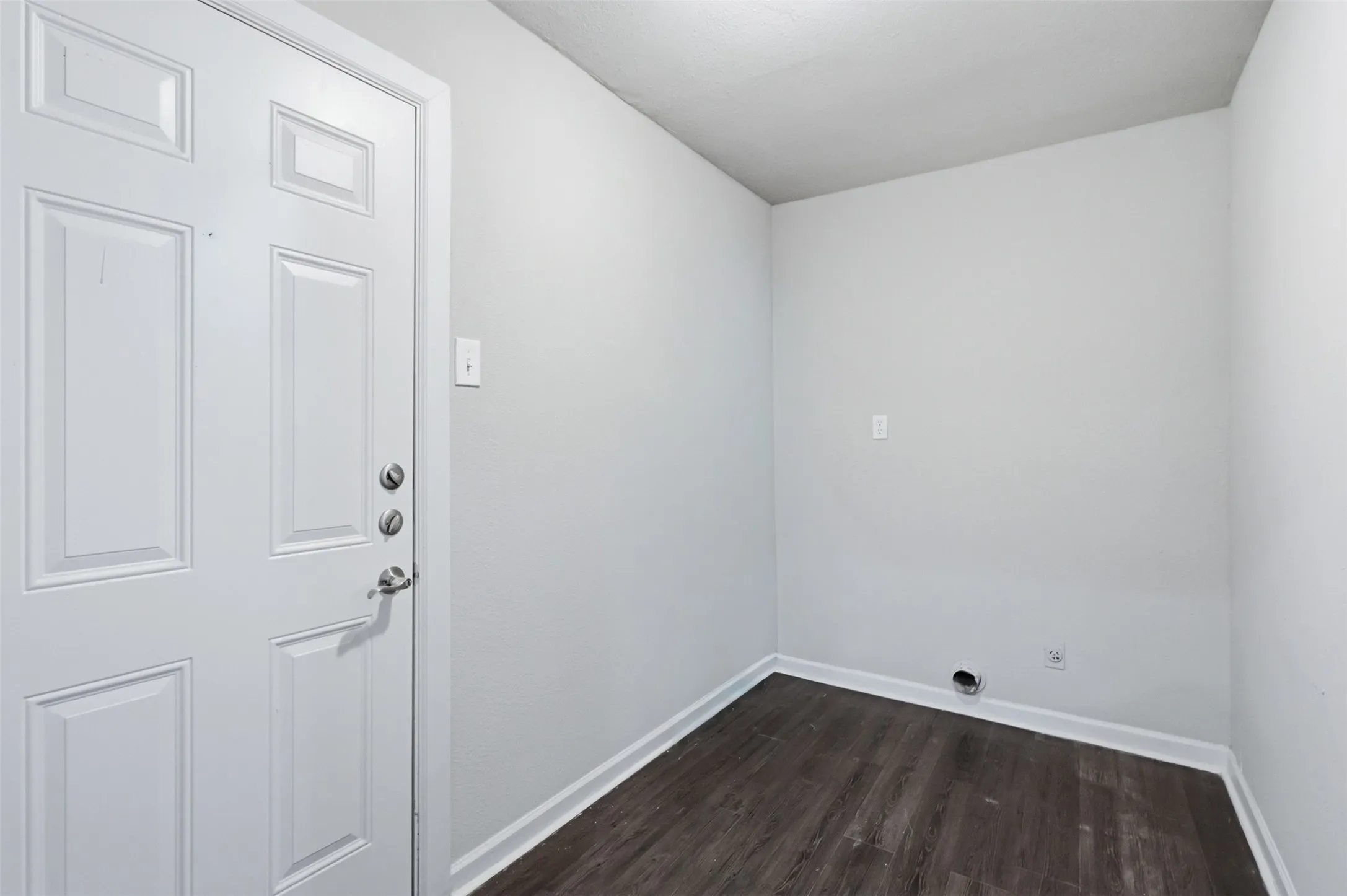 Large utility room with access to the backyard.