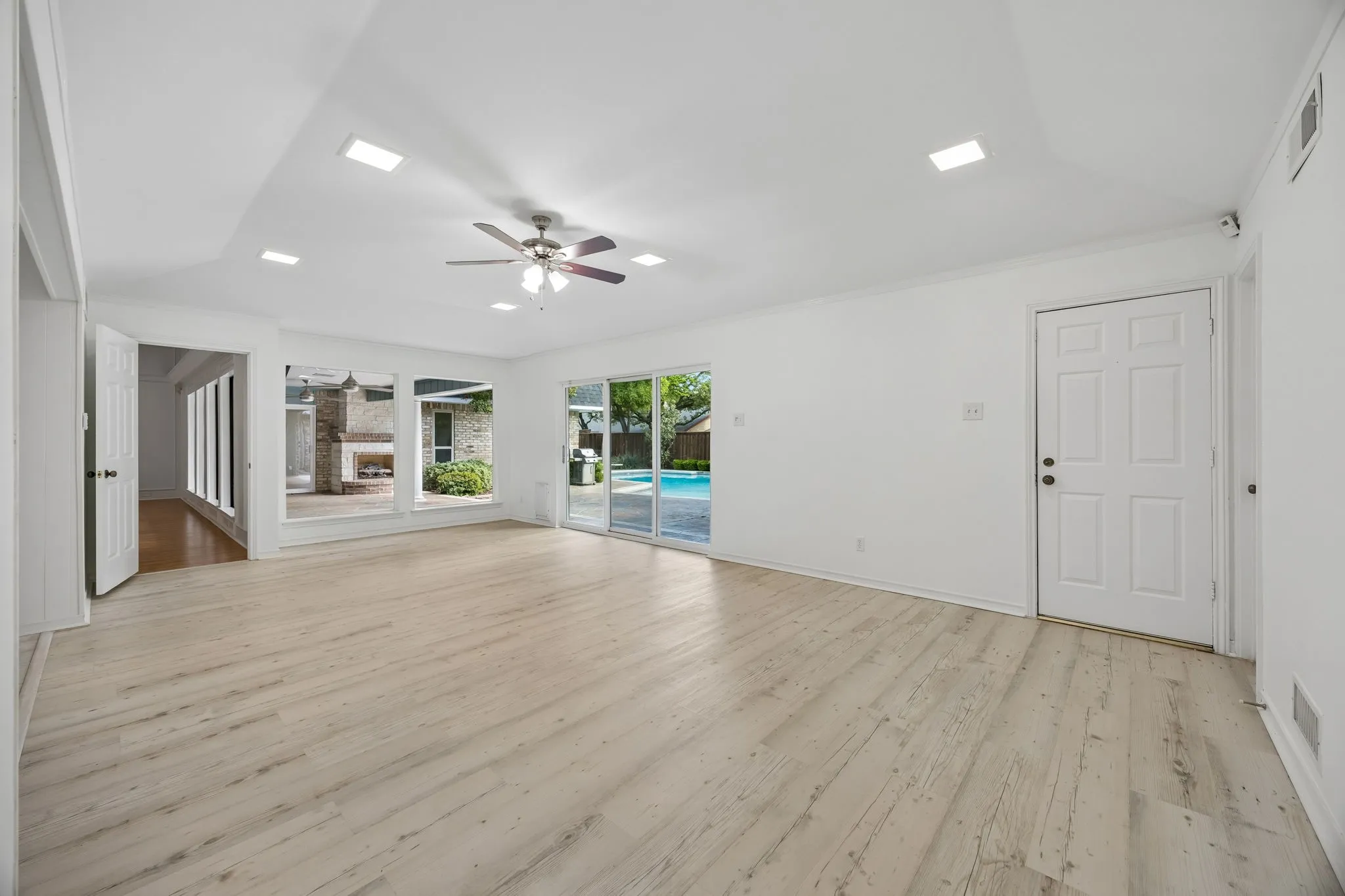 Large second living room that looks out over pool and patio