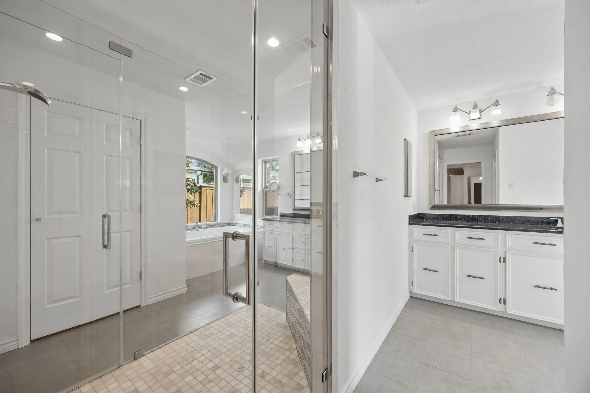 His and hers sinks and toilets connected by a walkin shower
