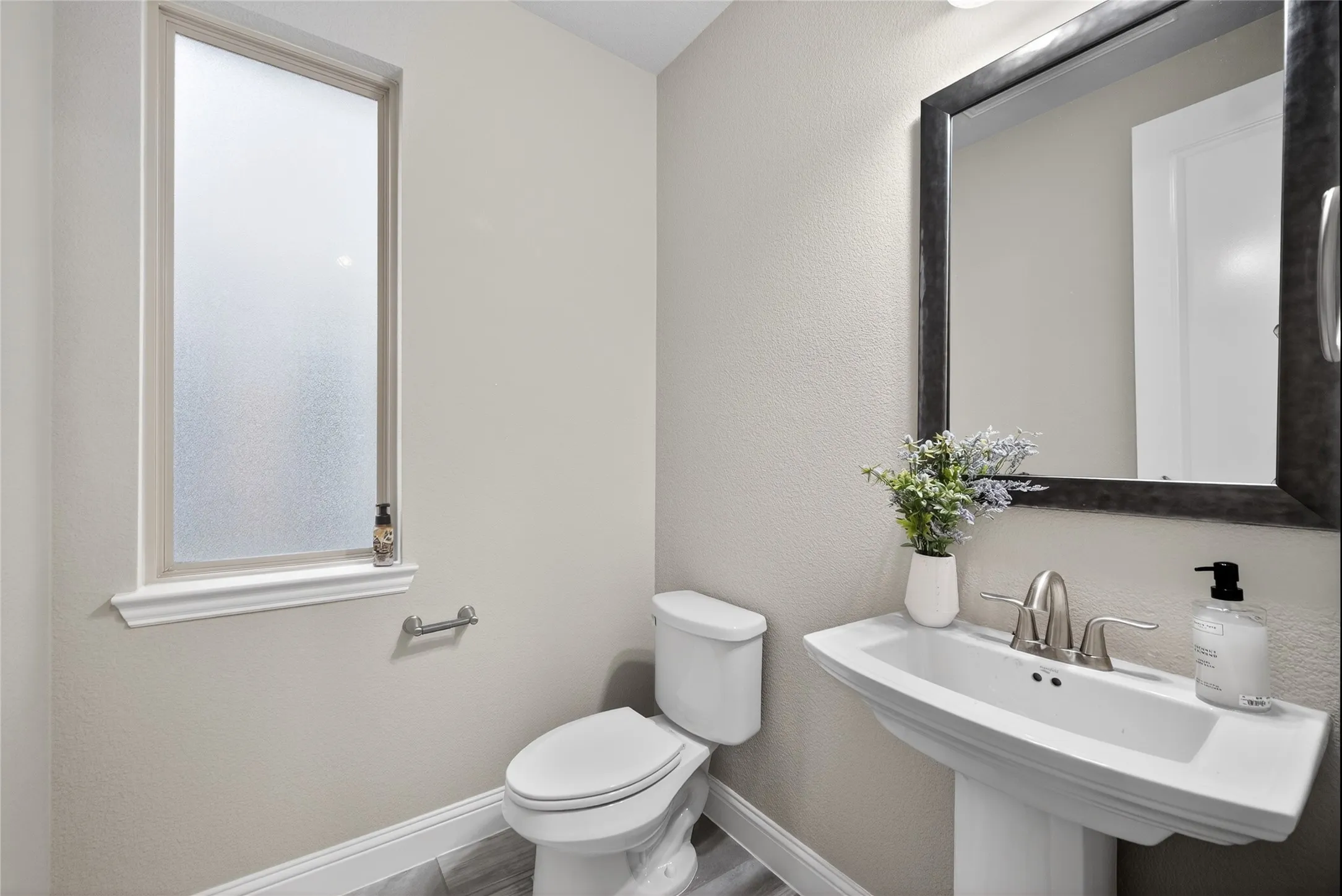 Half bath featuring toilet and a textured wall