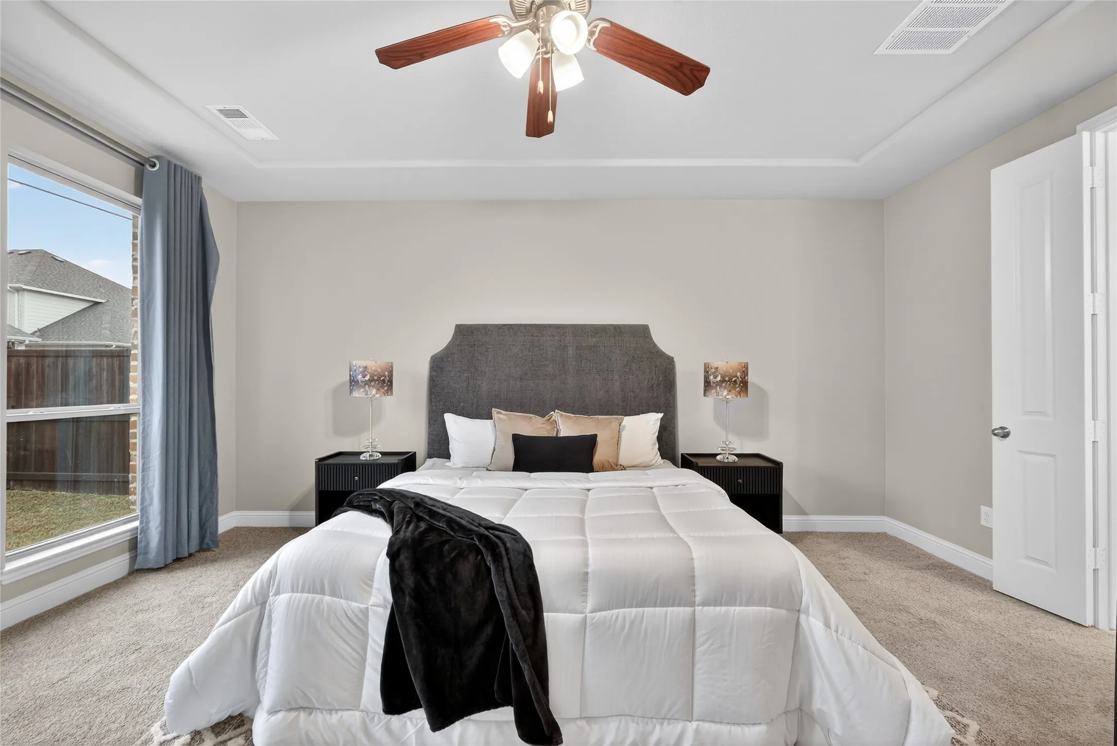 Bedroom with light carpet and ceiling fan