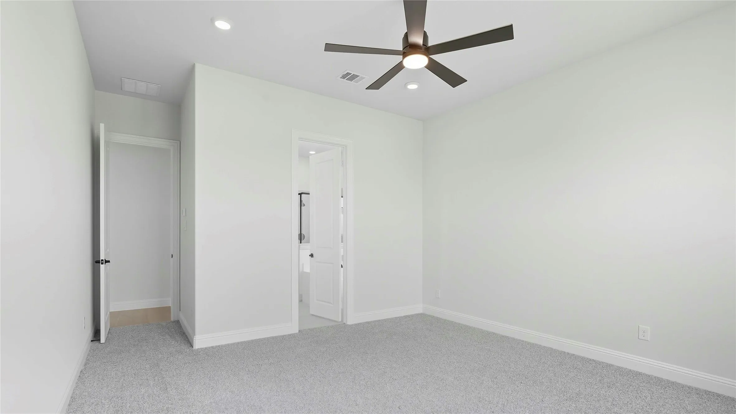 Unfurnished bedroom featuring light carpet, ceiling fan, and recessed lighting