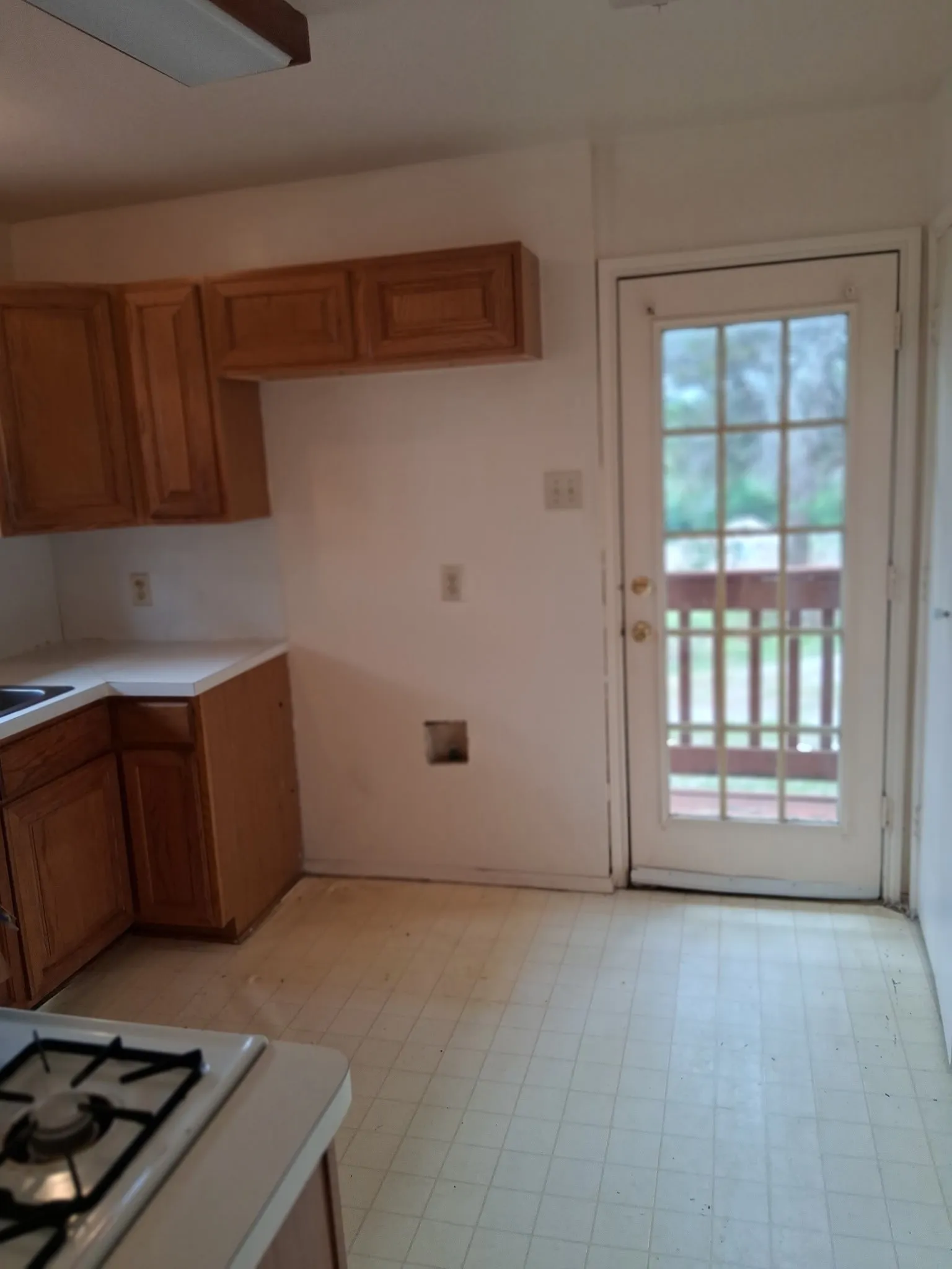 Kitchen area featuring wood-finish cabinetry and a white countertop