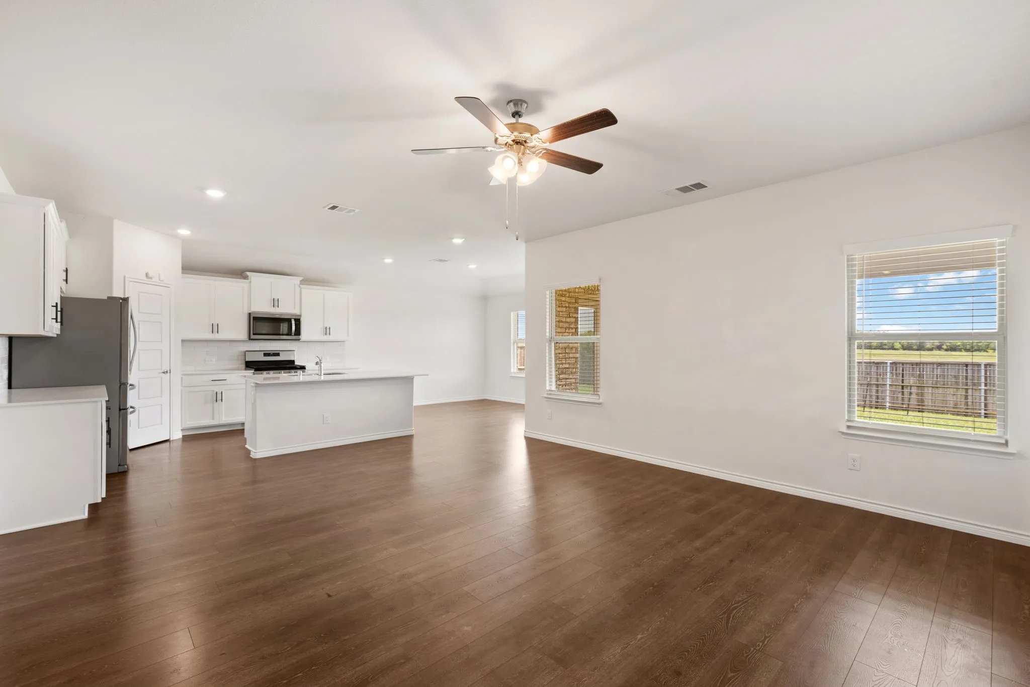 Open-concept living area featuring wood-finish flooring
