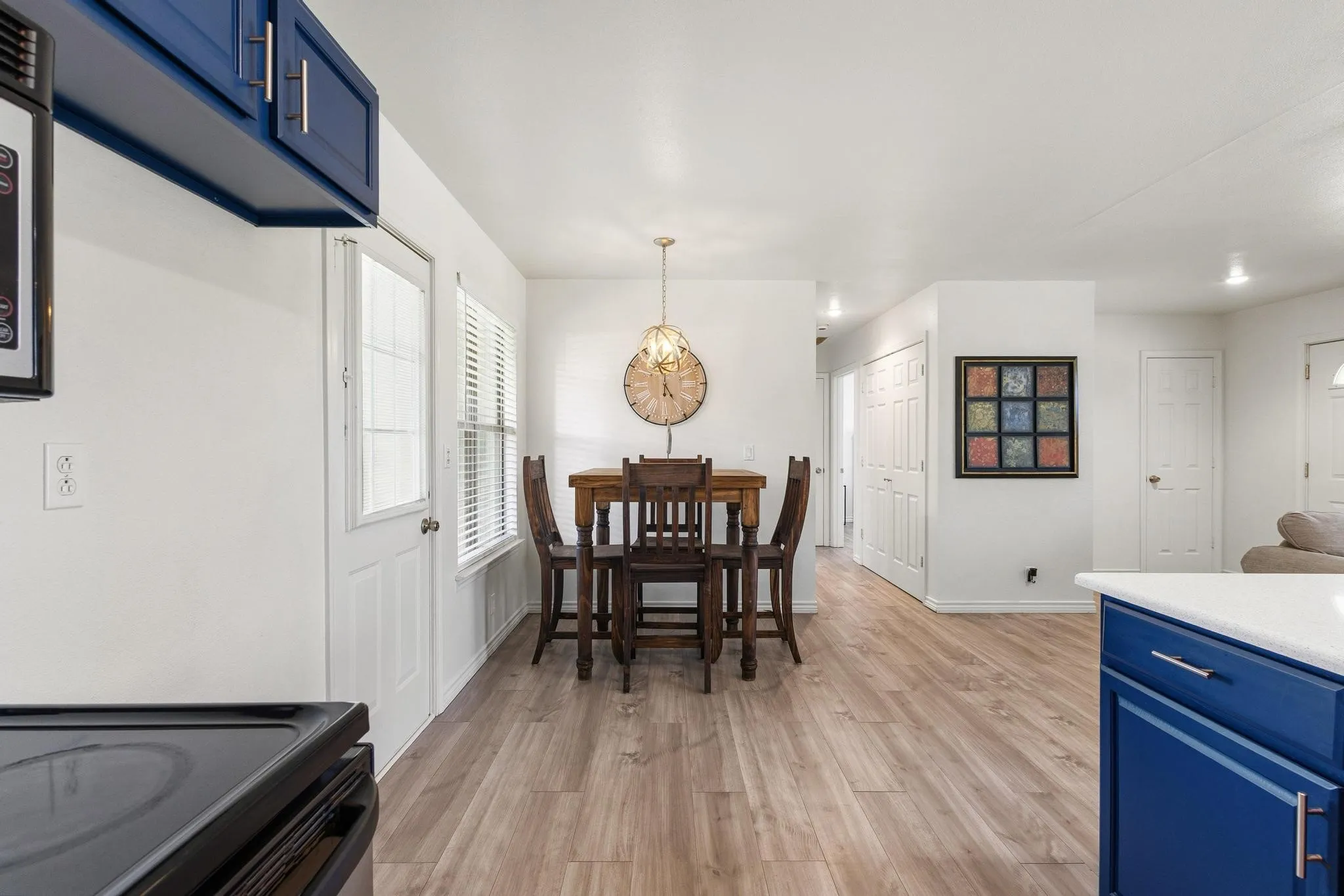 Dining space with light wood-style floors and baseboards