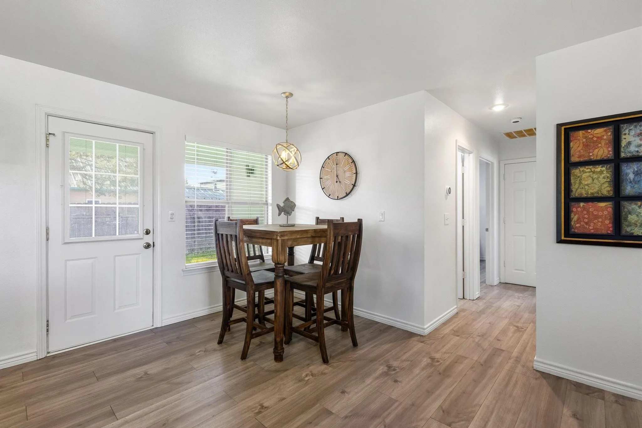Dining room featuring wood finished floors and a chandelier