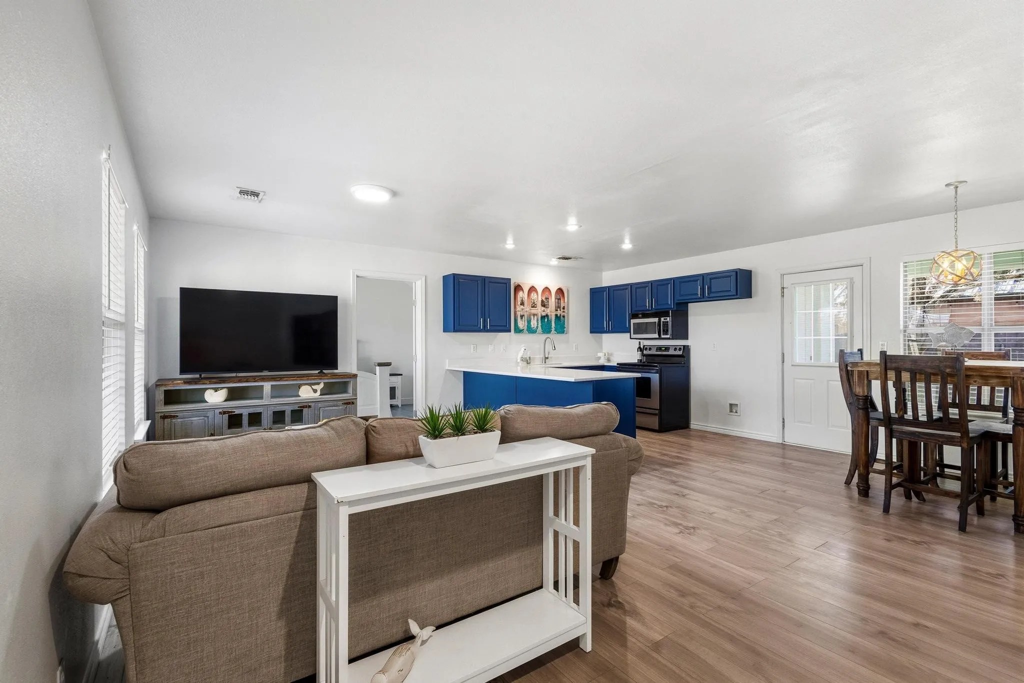 Living room featuring light wood-style floors and baseboards