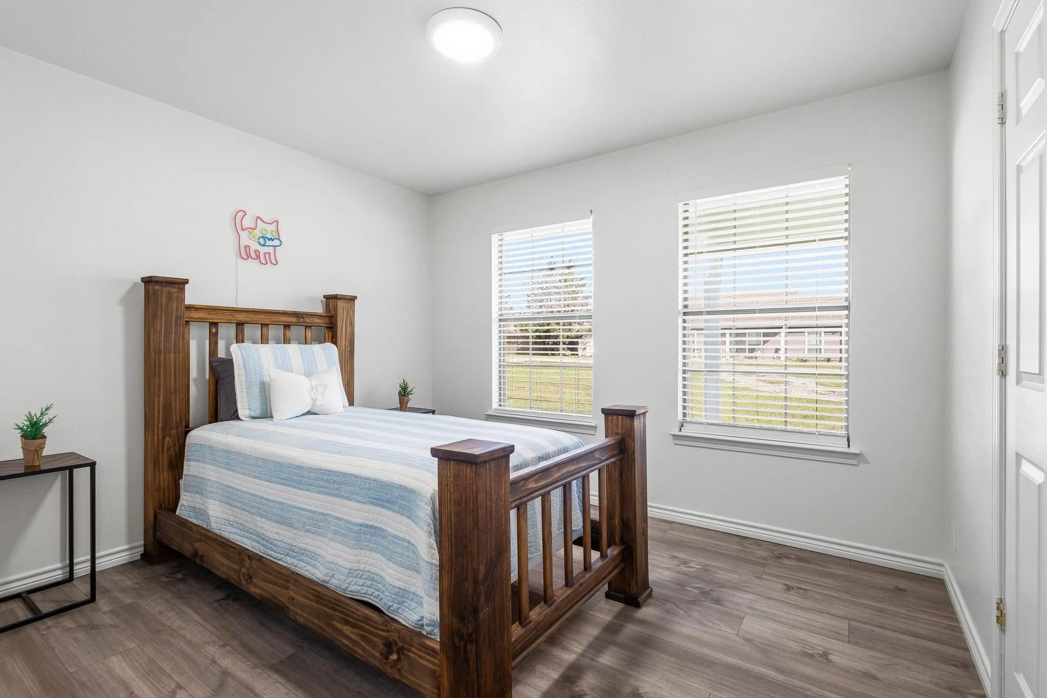 Bedroom featuring dark wood-style floors and baseboards