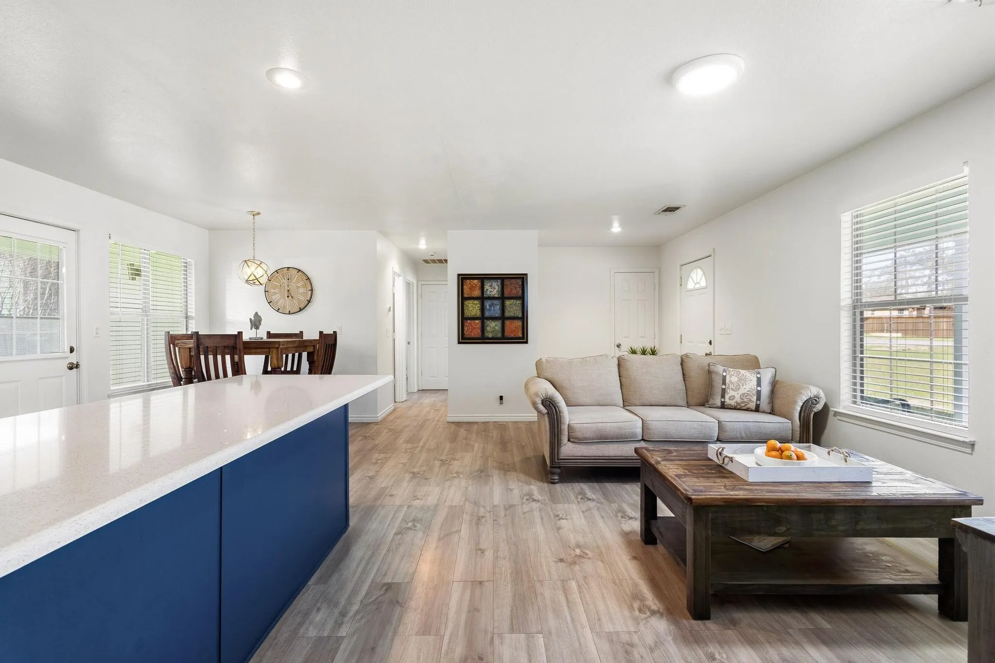 Living room featuring plenty of natural light, light wood finished floors, and recessed lighting