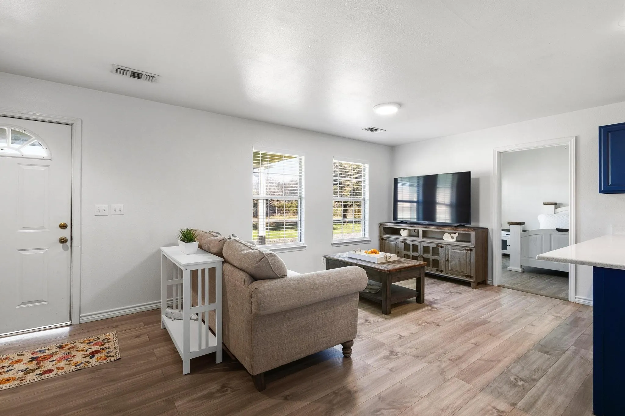 Living area with light wood-style floors and baseboards