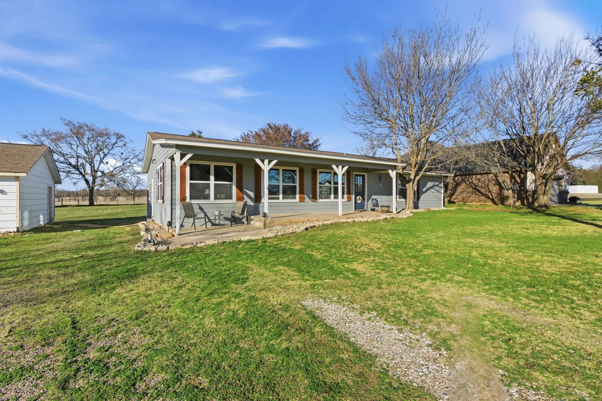 View of front of house featuring a porch and a front lawn