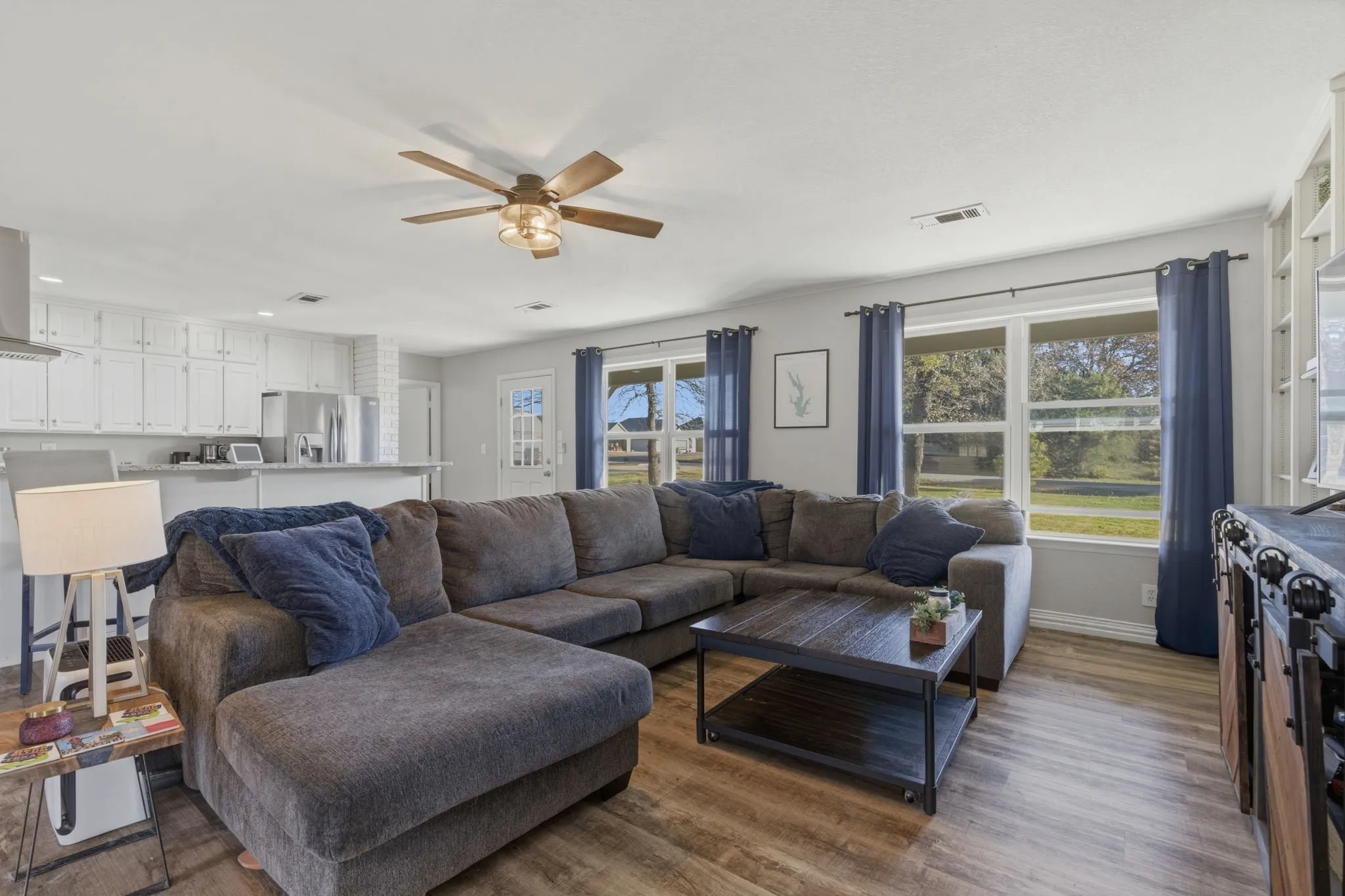 Living area featuring a ceiling fan, wood finished floors, and recessed lighting