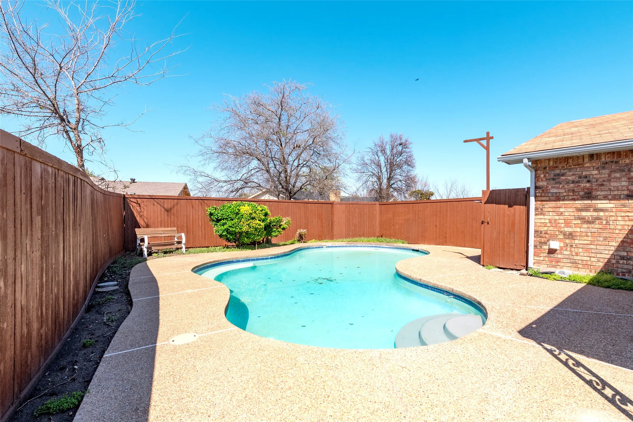 View of pool with a fenced backyard and patio surround
