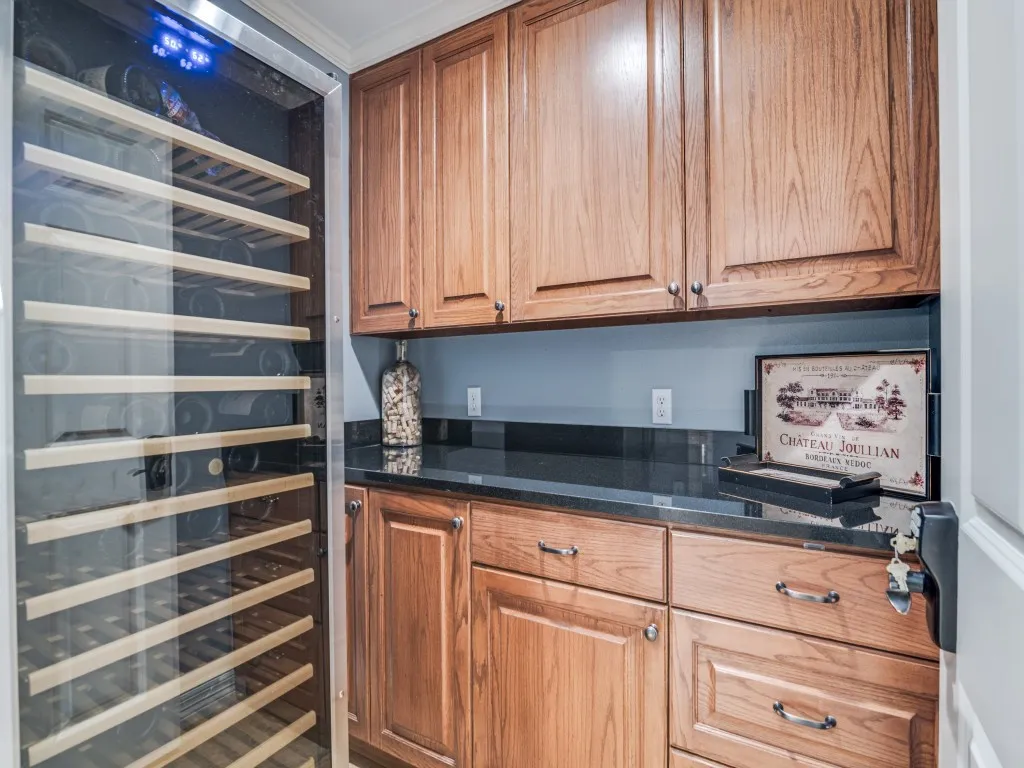 Locked room off game room to store wine and adult beverages in a secure space.  Wine fridge does NOT convey with the house.