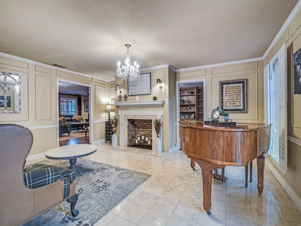 A formal first floor living area with faux fireplace, plantation shutters and built-ins.
