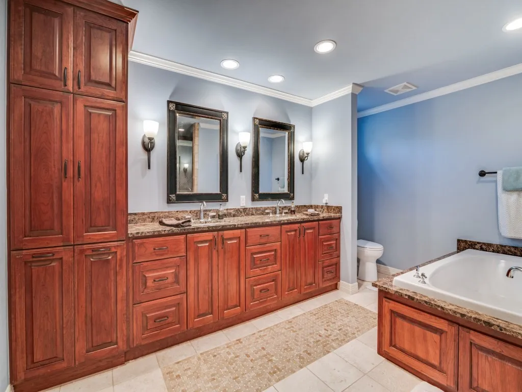 The primary bath has dual sinks, granite countertops and abundant storage space.