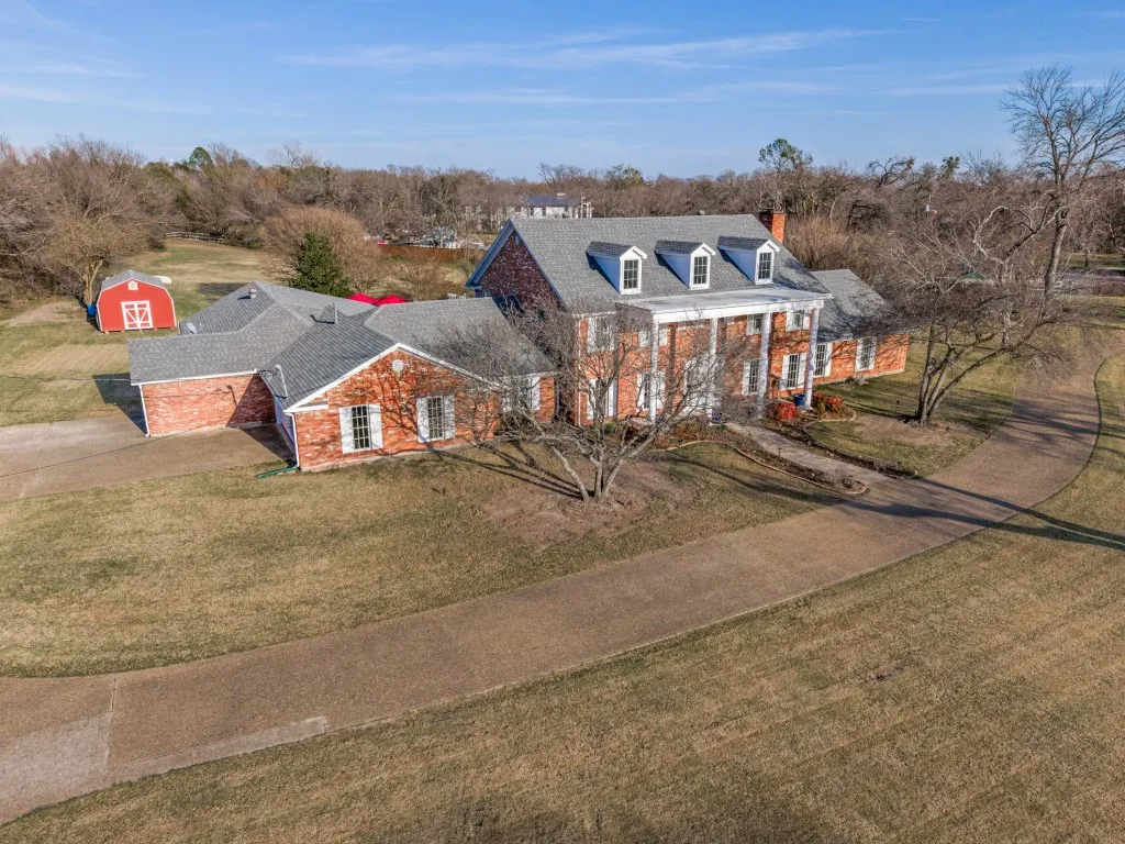 Front view of the property with extended drive, 3-car garage, and a 24 x 16 barn.