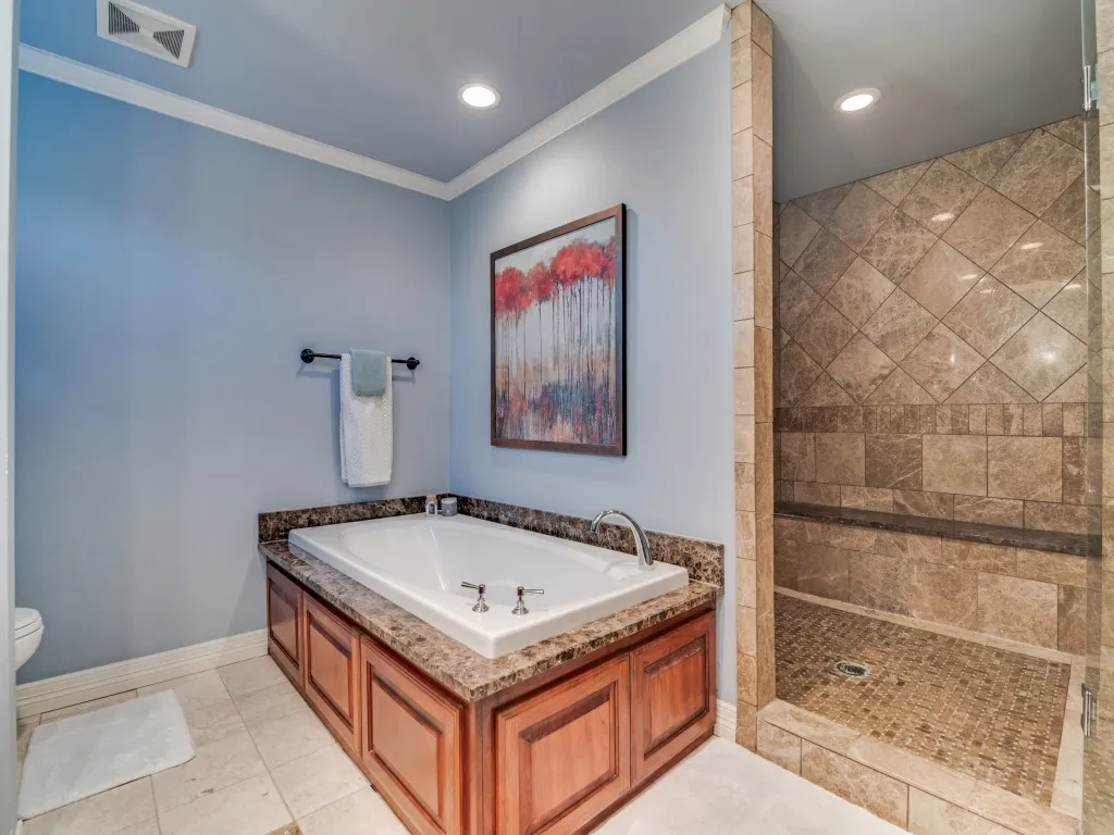 Garden tub and huge walk-in tiled shower in the primary bath.