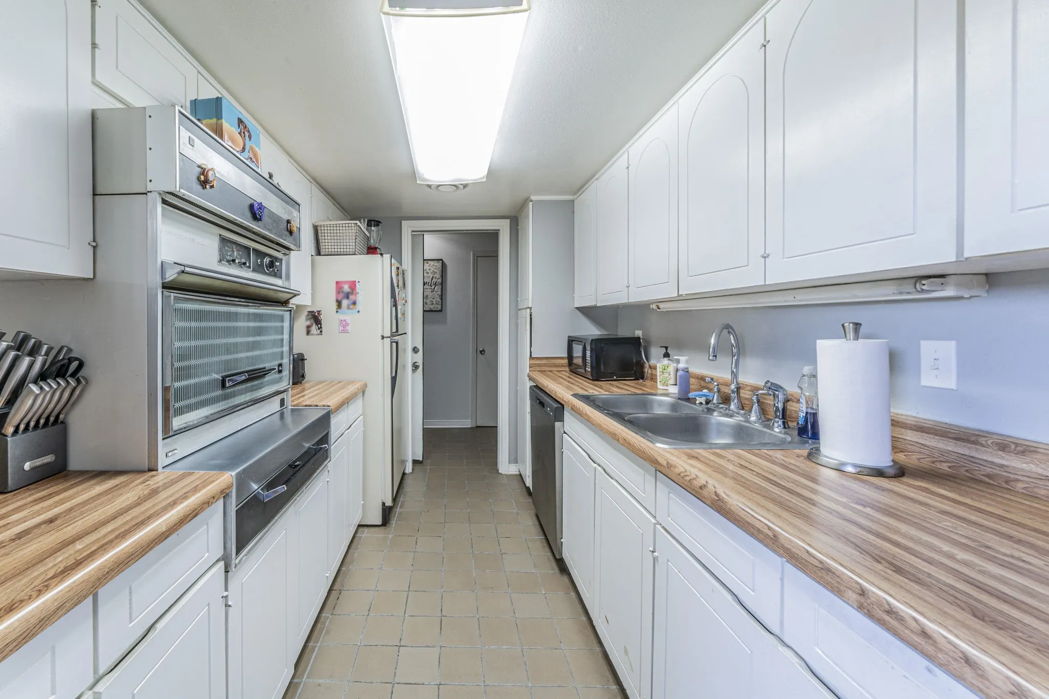 Galley kitchen with lots of counter space and working original pull out stove.