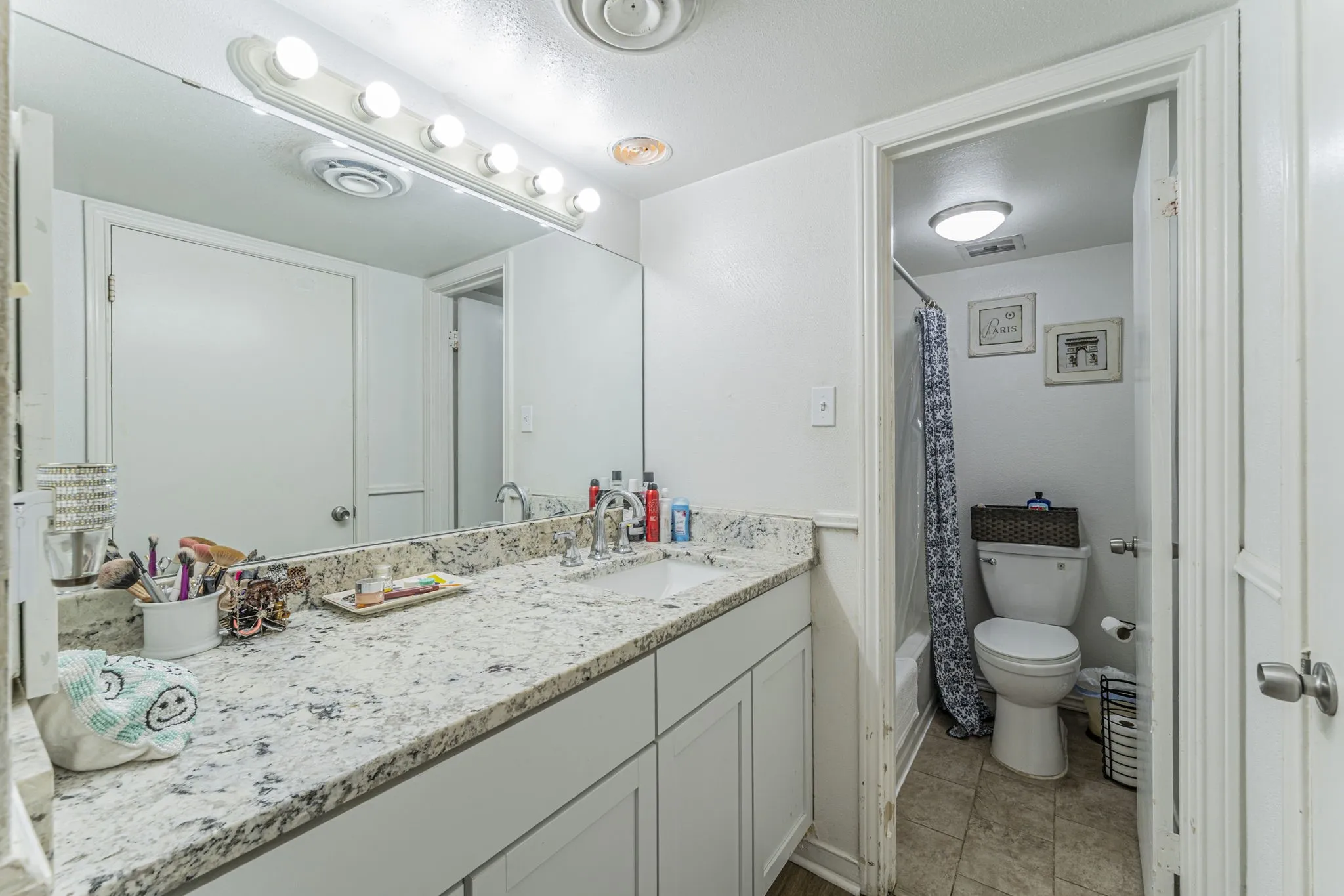 Completely updated ensuite bathroom featuring granite vanity.