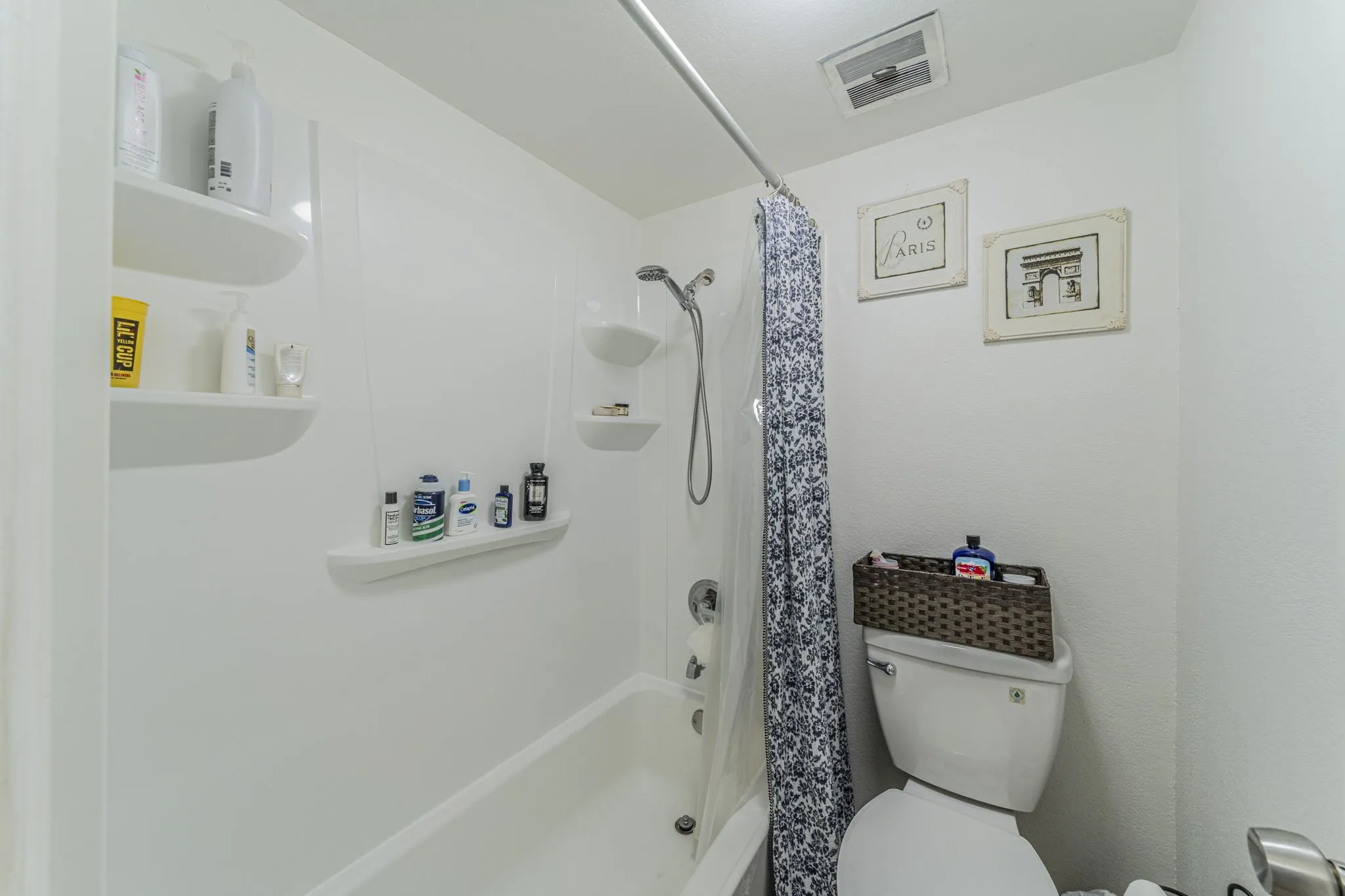 Updated shower-tub combo with shelves.