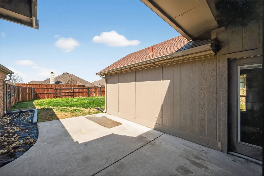 Fenced backyard with a patio