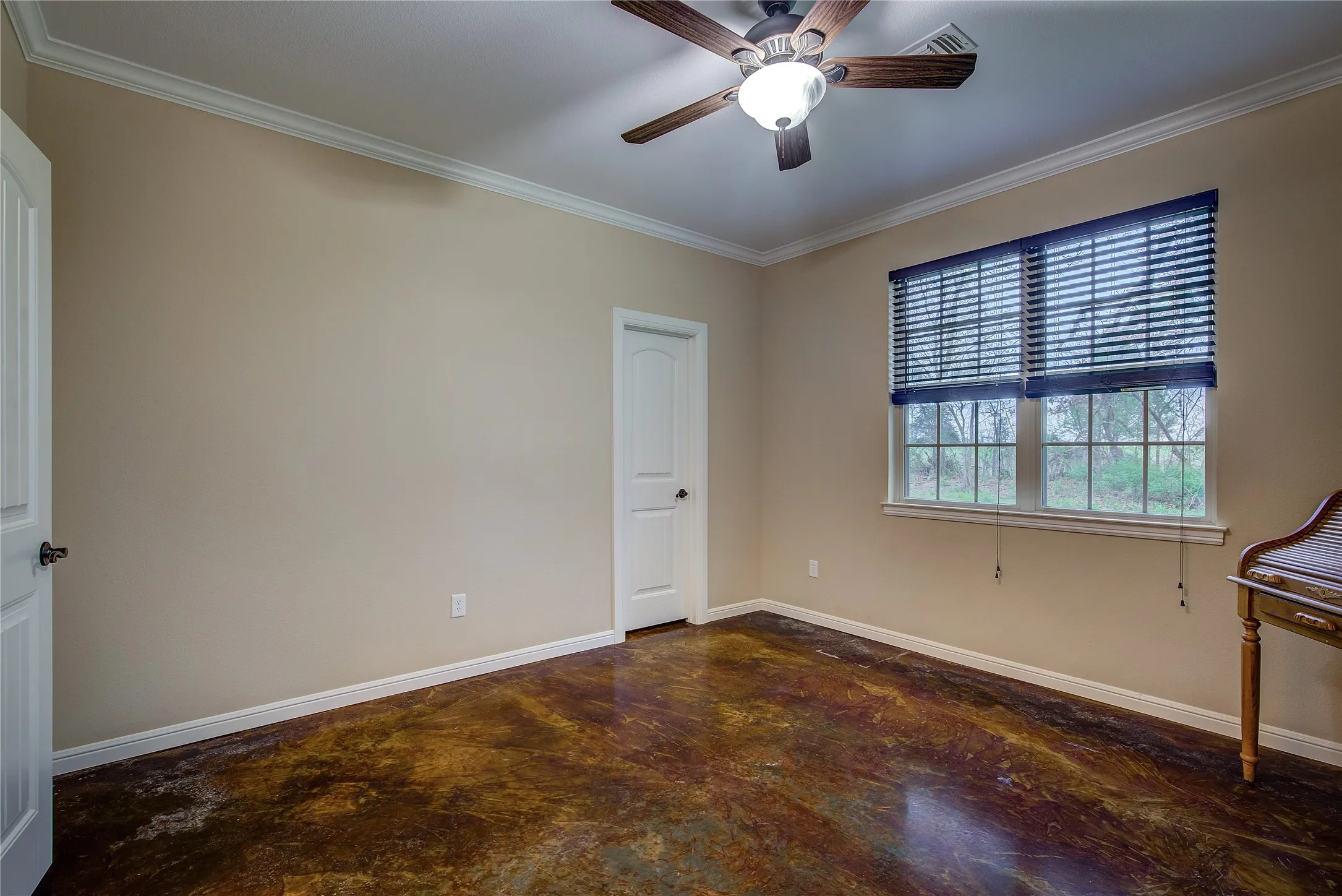 Third bedroom measuring 12’6” x 13’2”, featuring a walk-in closet, updated stained concrete flooring.