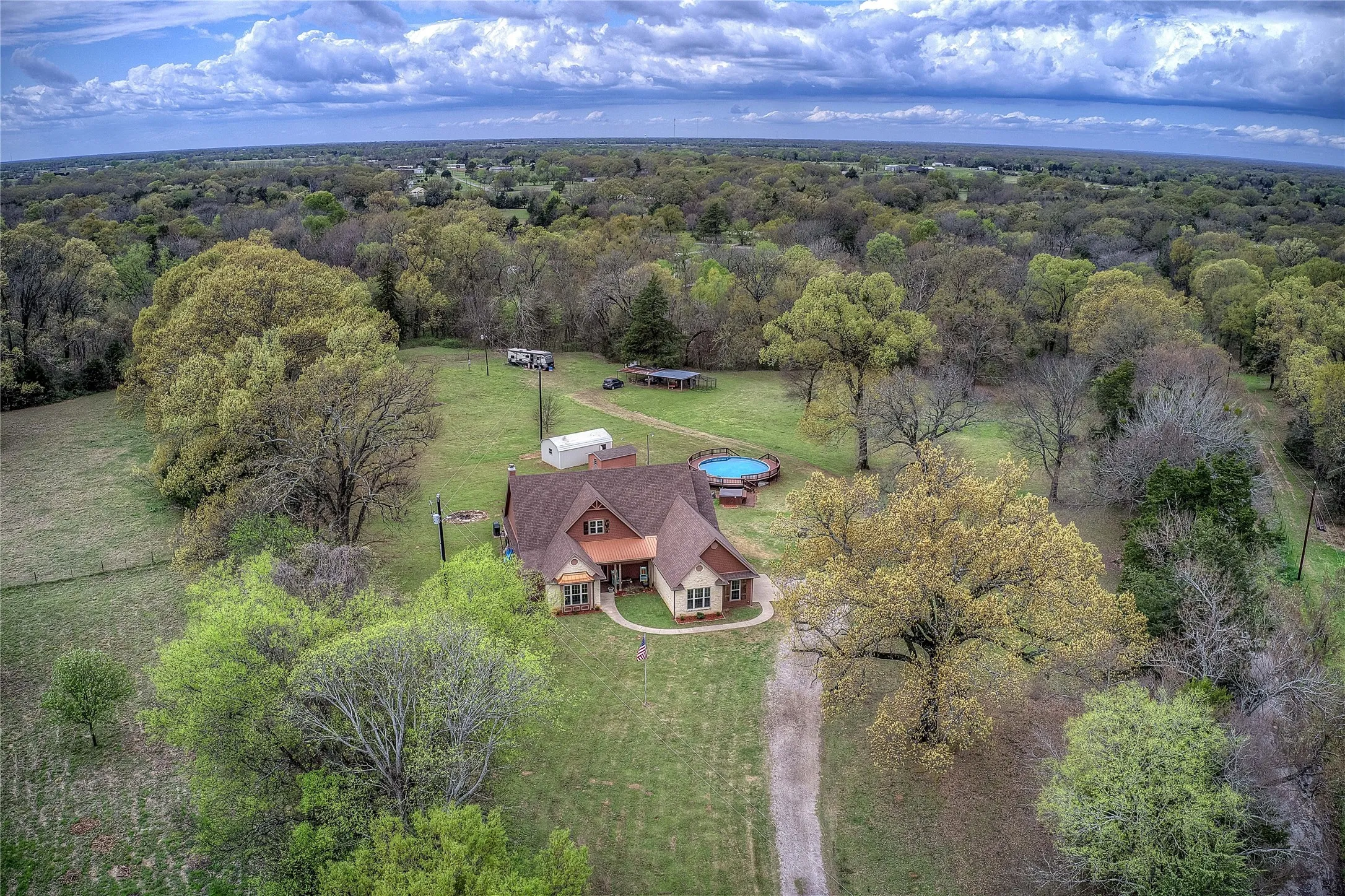 Private country retreat with multiple storage sheds, an above-ground pool with new decking, hot tub, and a private RV hookup with its own septic and electric meter.