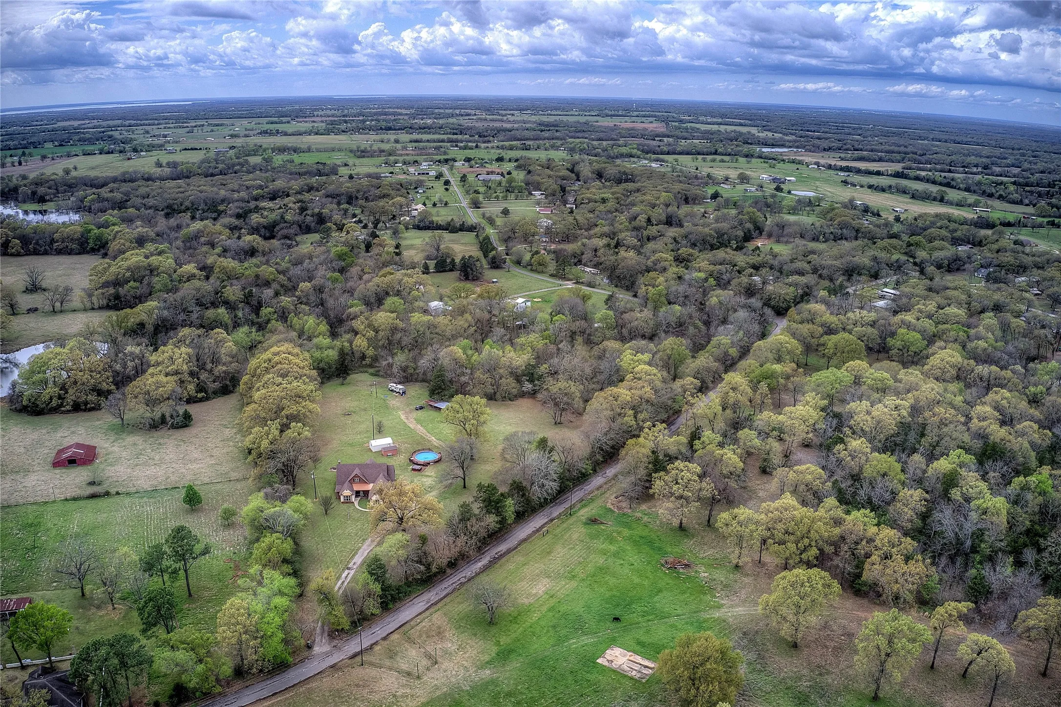 Private country retreat with multiple storage sheds, an above-ground pool with new decking, hot tub, and a private RV hookup with its own septic and electric meter.