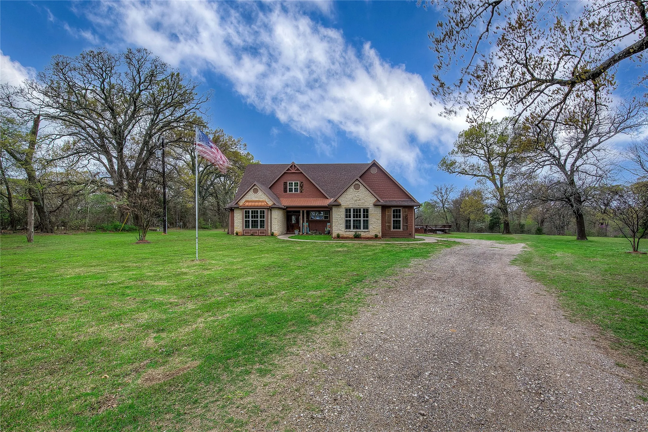 Private country retreat with a winding drive and mature trees.