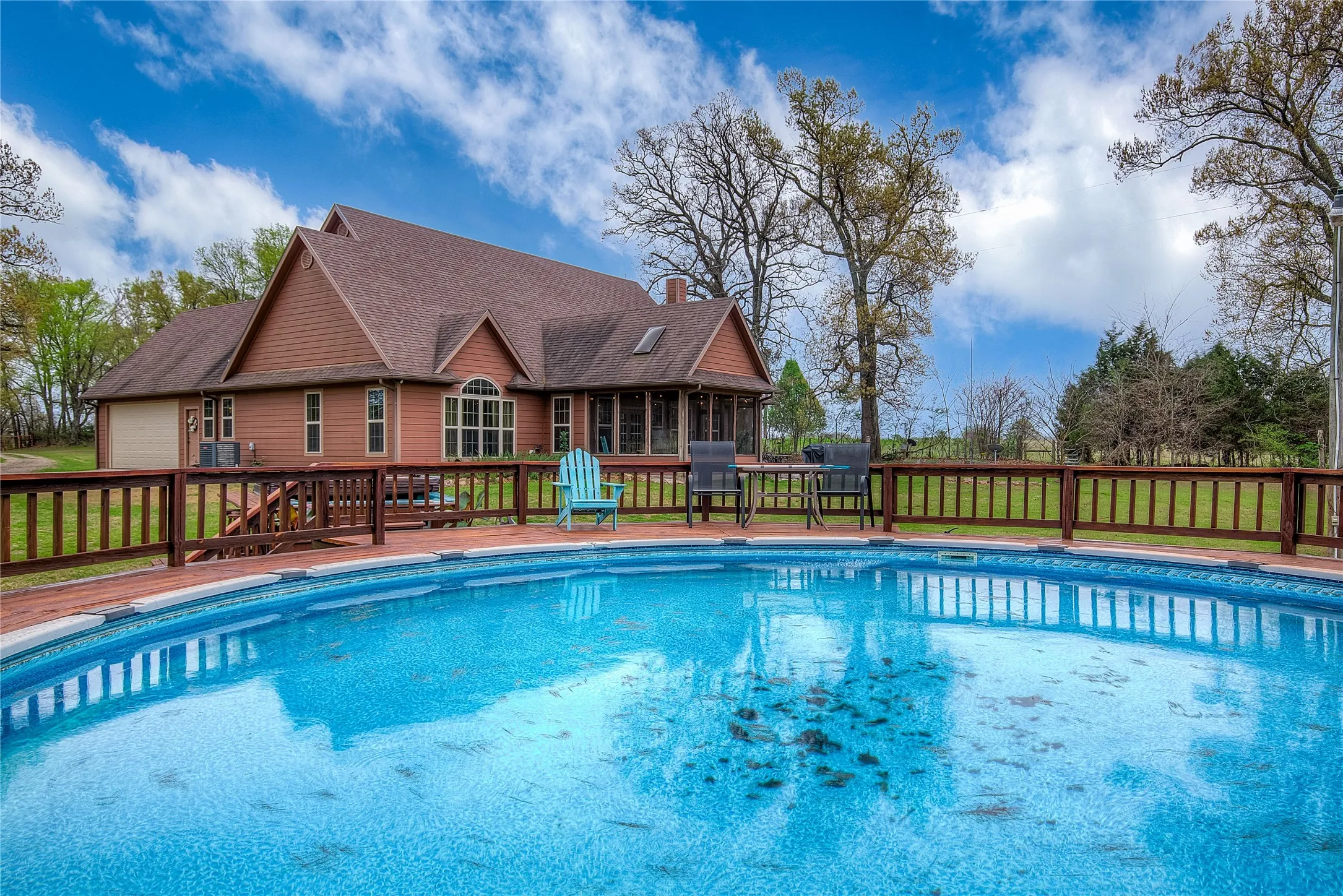 View of the swimming pool with updated decking and a relaxing hot tub.