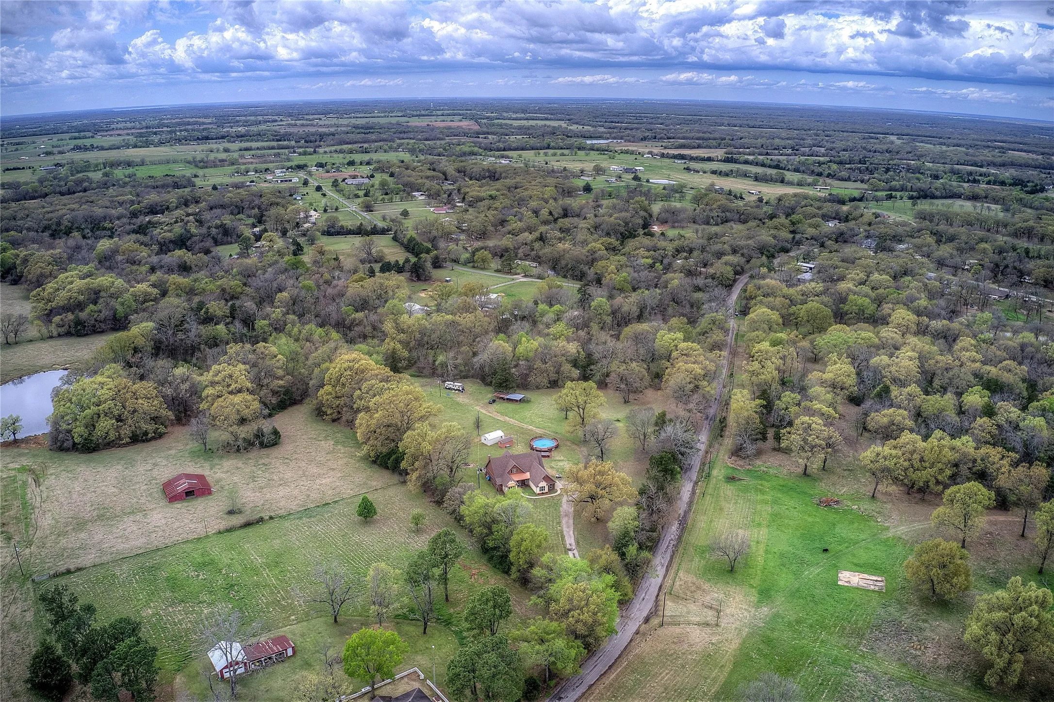 Private country retreat with multiple storage sheds, an above-ground pool with new decking, hot tub, and a private RV hookup with its own septic and electric meter.