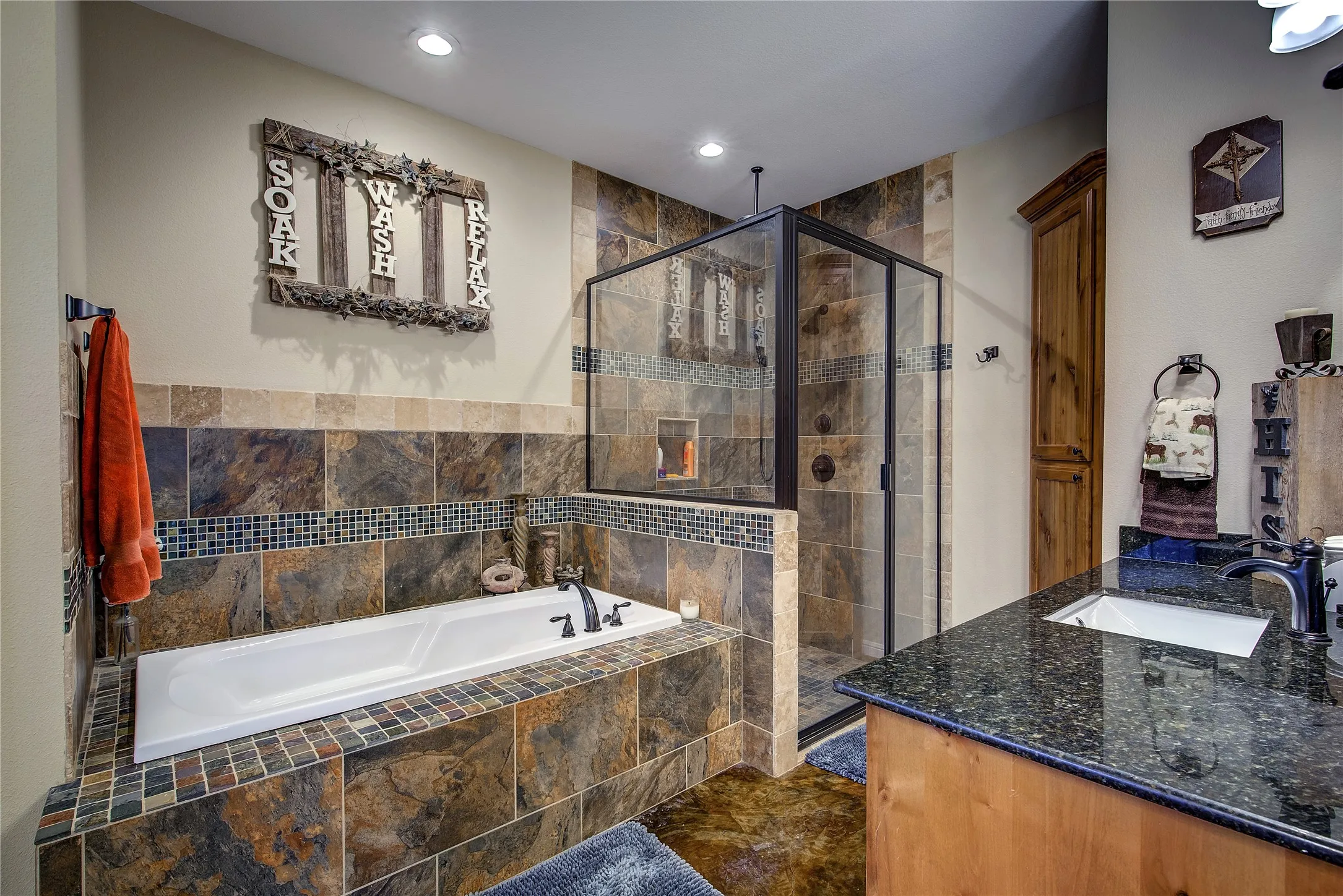 En suite bathroom measuring 17’6” x 12’2”, featuring dual vanities, a garden tub, linen closet, separate custom shower with rainfall showerhead, and his-and-hers walk-in closets.