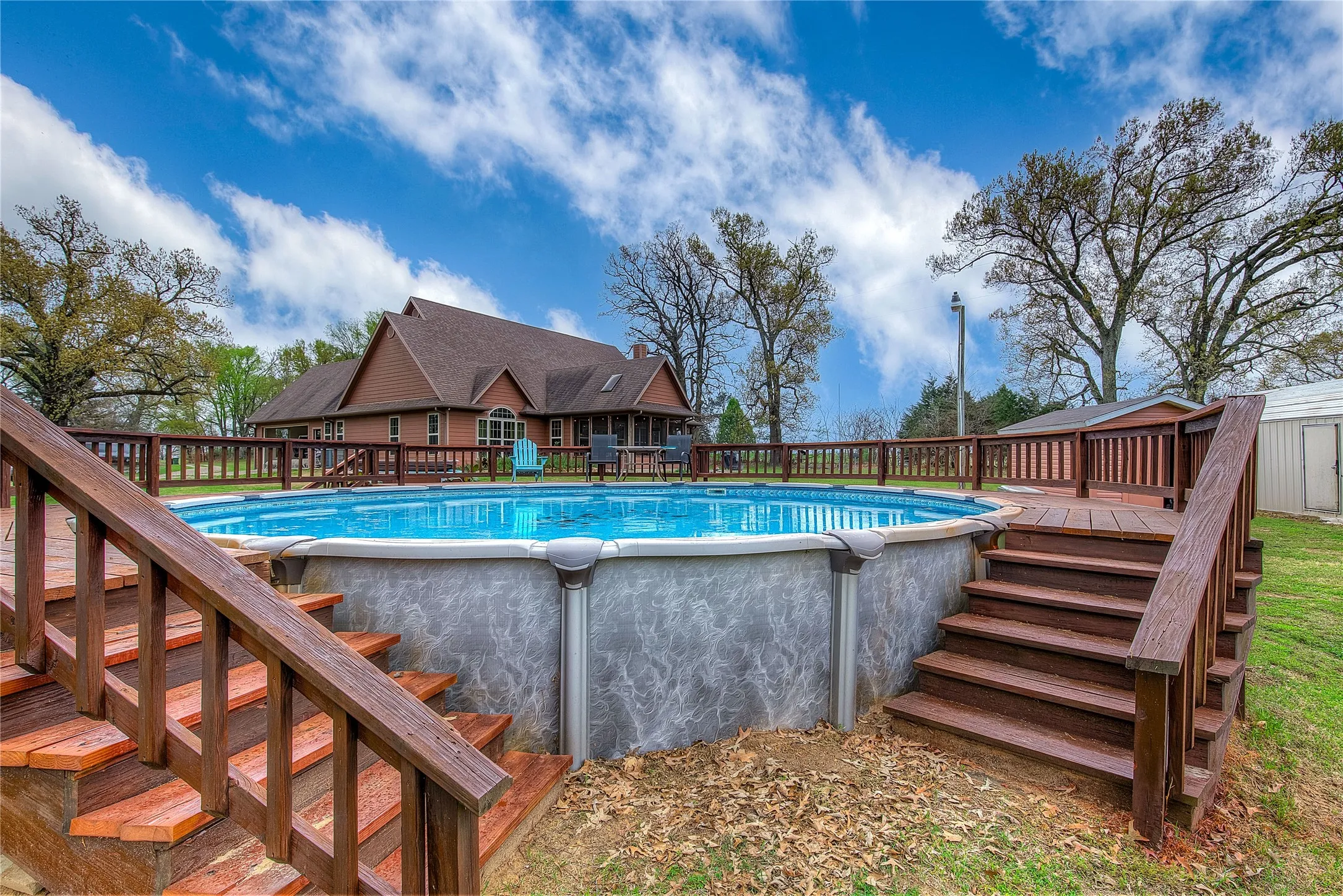 View of the swimming pool with updated decking and a relaxing hot tub.