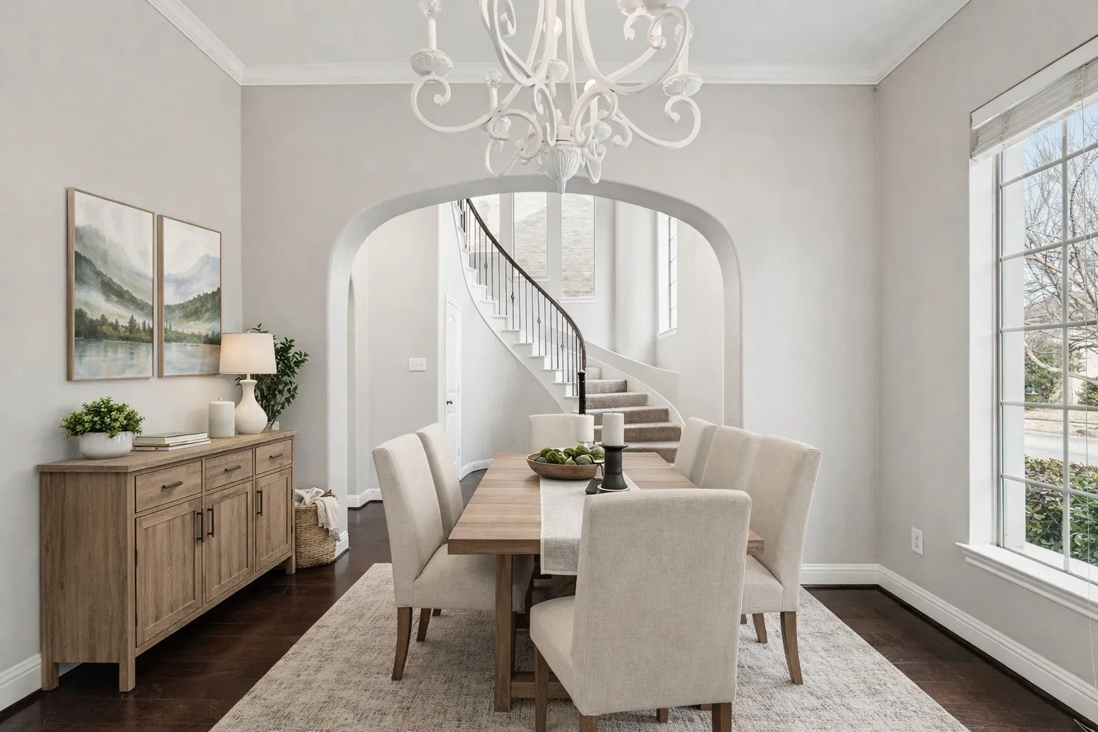 Dining space featuring a chandelier, ornamental molding, dark wood-style flooring, and arched walkways