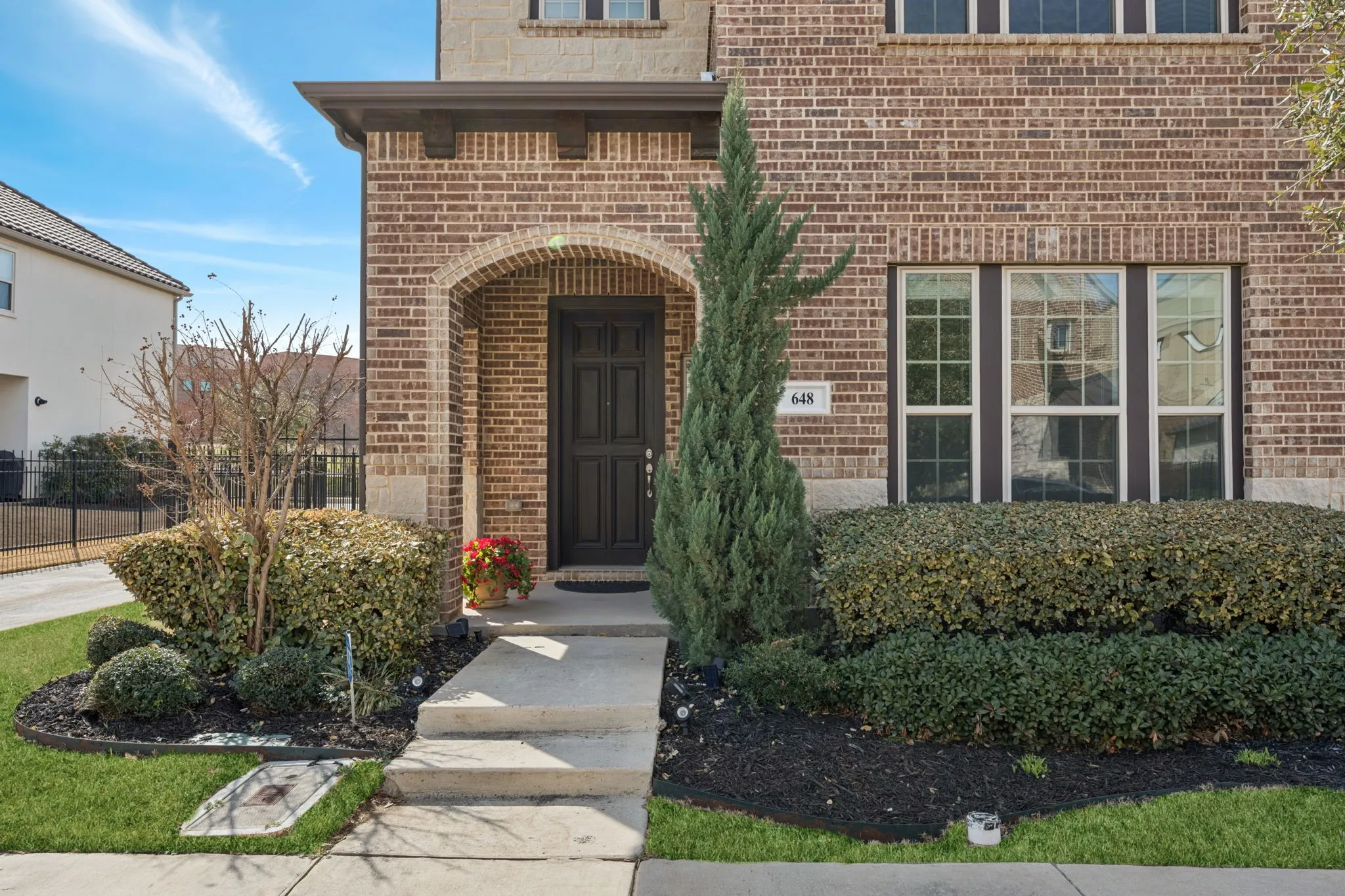 View of exterior entry featuring brick siding